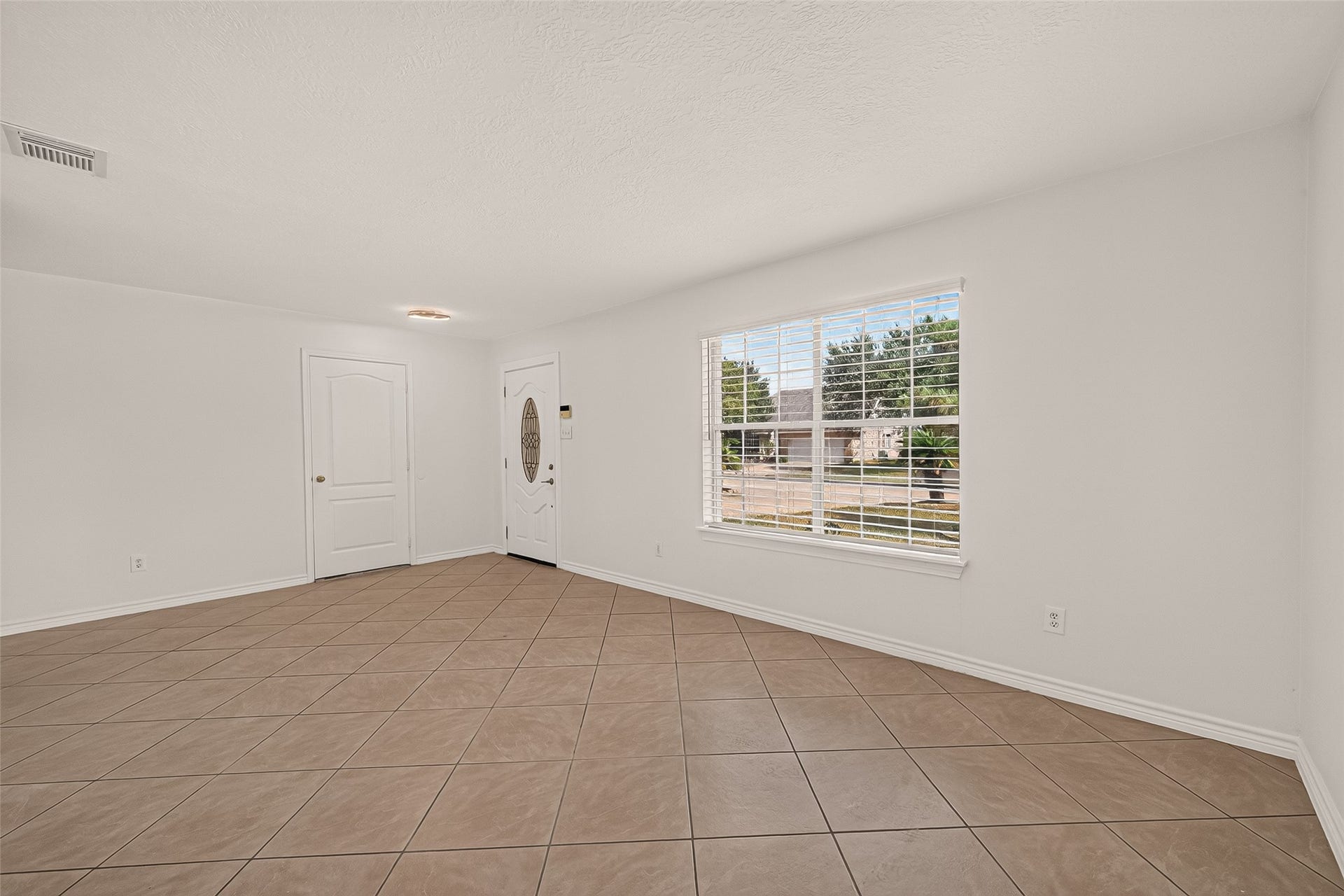 3111 Lantern Bay Lane, Katy, TX 77449 Step inside a welcoming living room where a large front window brings in natural light and tile flooring offers easy everyday living.