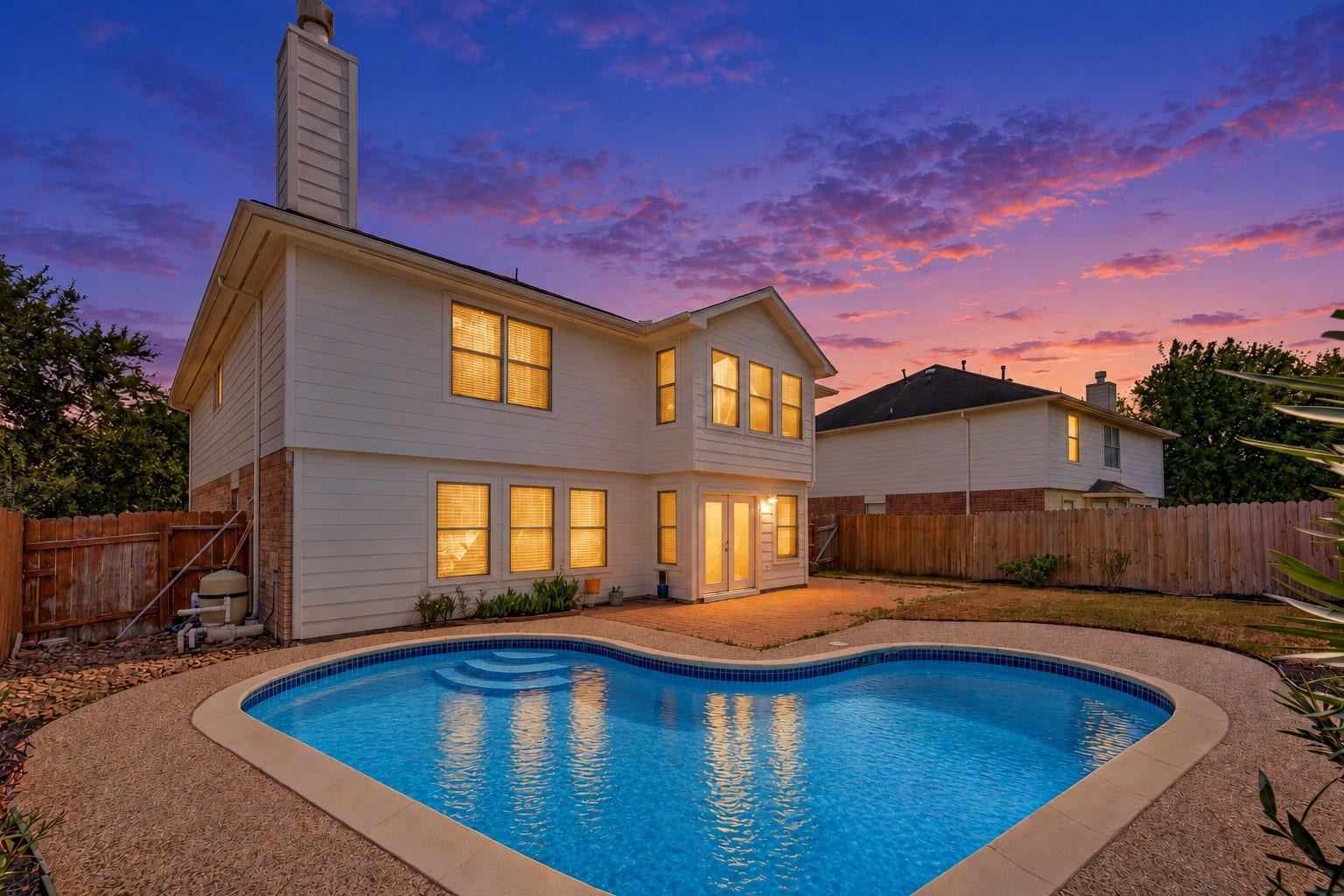 3111 Lantern Bay Lane, Katy, TX 77449 Picture evenings by the pool with the patio just steps from the back door. NEW ROOF 2026 POOL REFINISHED 2026 **Digitally edited twilight image.