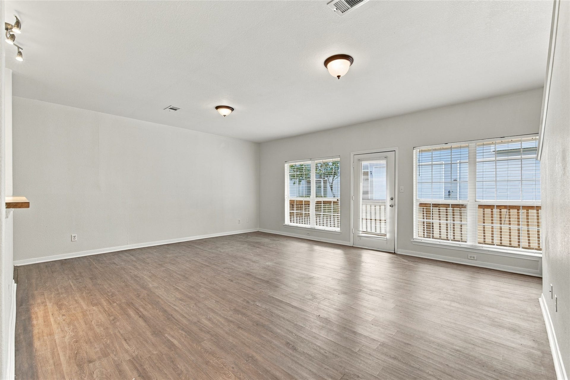 another view of family room looking towards windows and door leading to the deck at the back of the unit