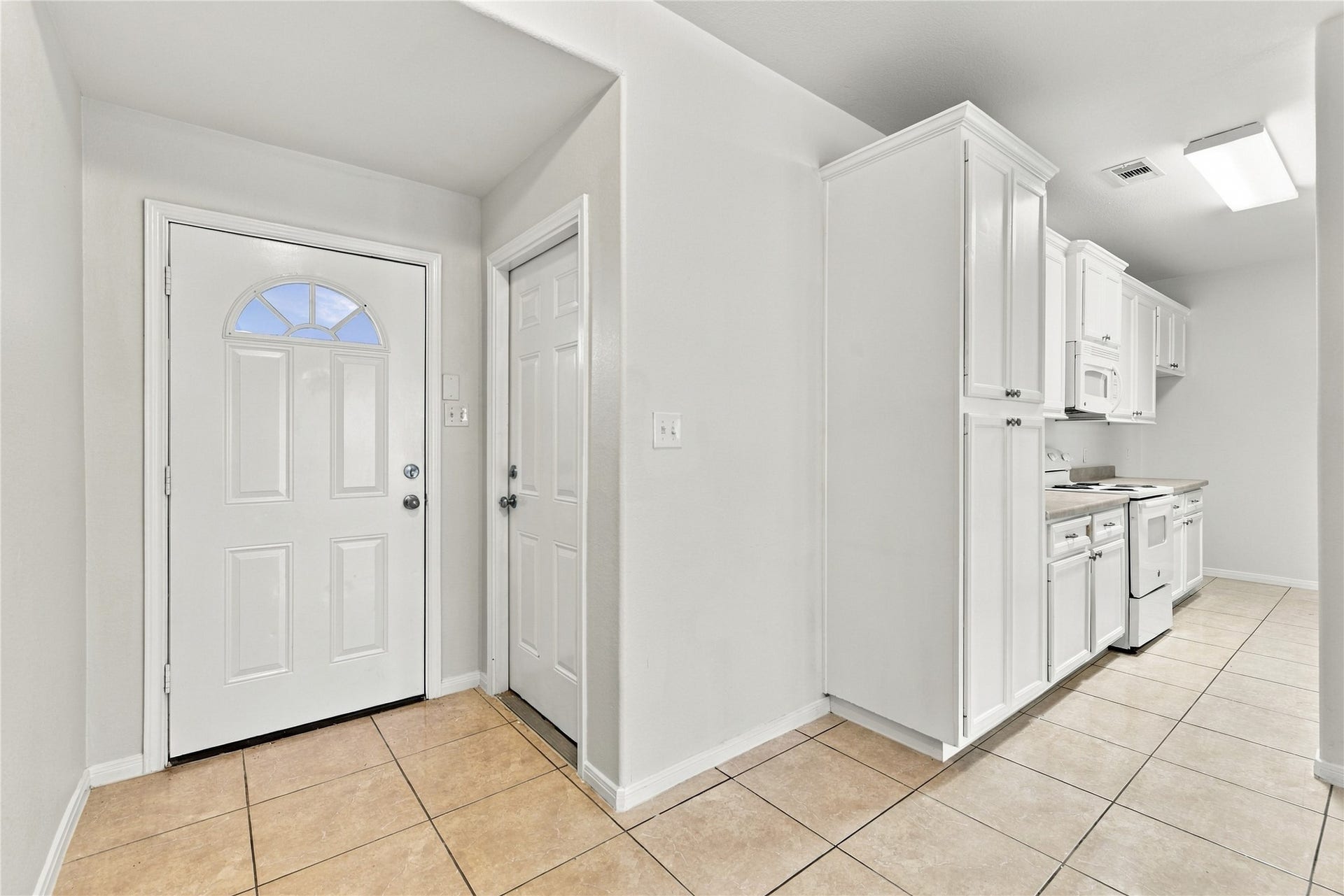 front door from inside, garage door, kitchen