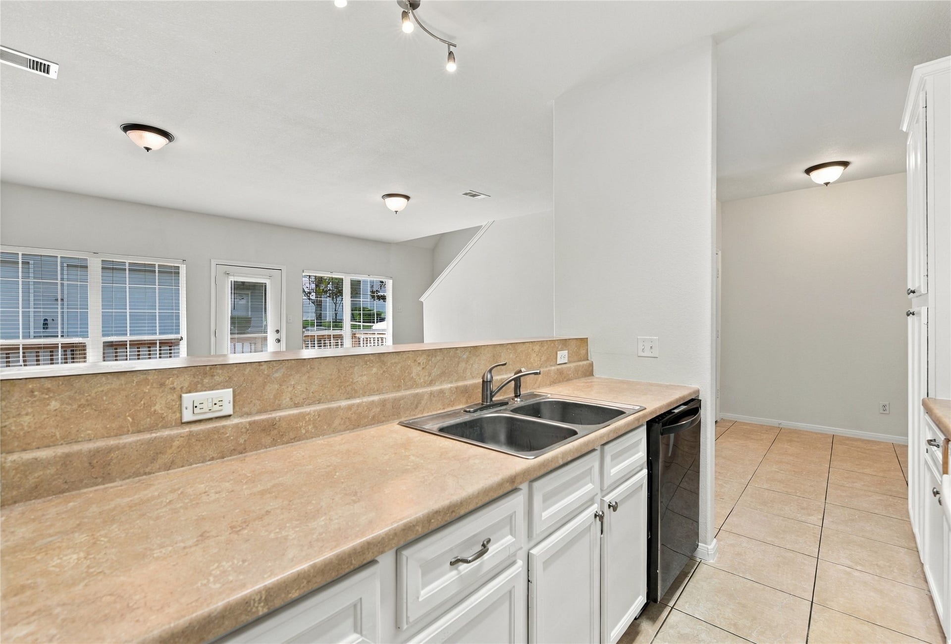kitchen looking to family room and back of house