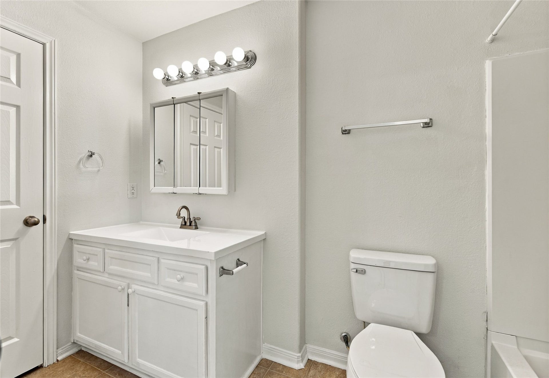 primary bathroom door - on the left is linen closet, vanity, toilet, tub/shower on the right