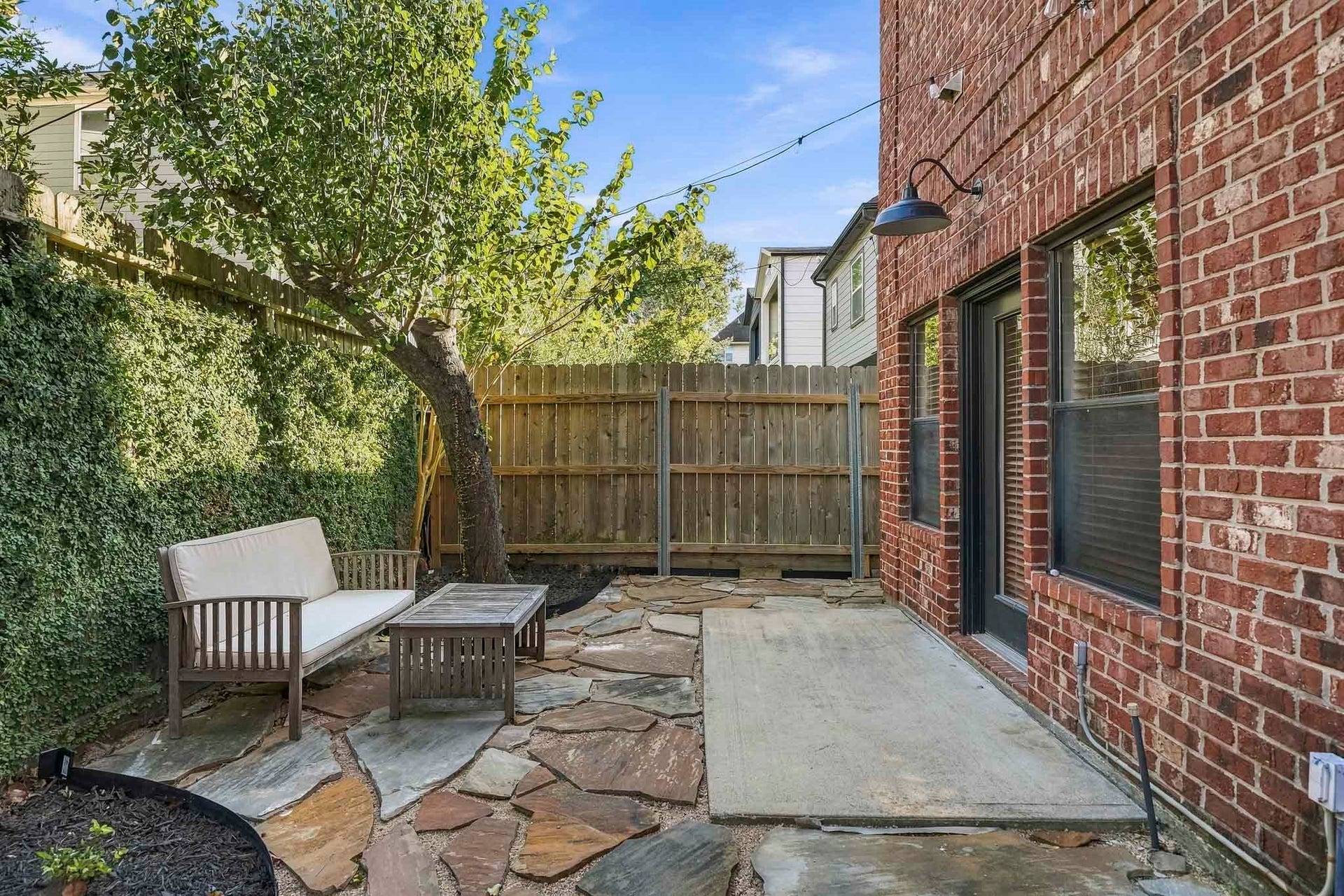 910 Malone Street, #106, Houston, TX 77007 A gated entry beside the front door provides private access to the side patio, creating a secluded outdoor space just steps from the home's entrance.