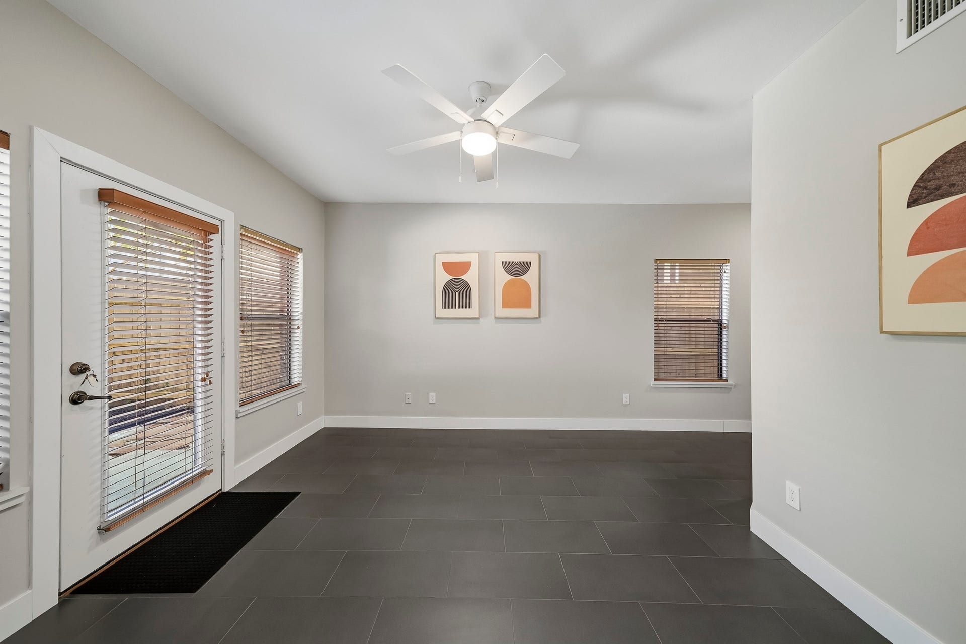 910 Malone Street, #106, Houston, TX 77007 Located on the first floor, the third bedroom features tile flooring, recessed lighting and a ceiling fan with an integrated light, offering a comfortable, versatile space with a clean, contemporary finish.
