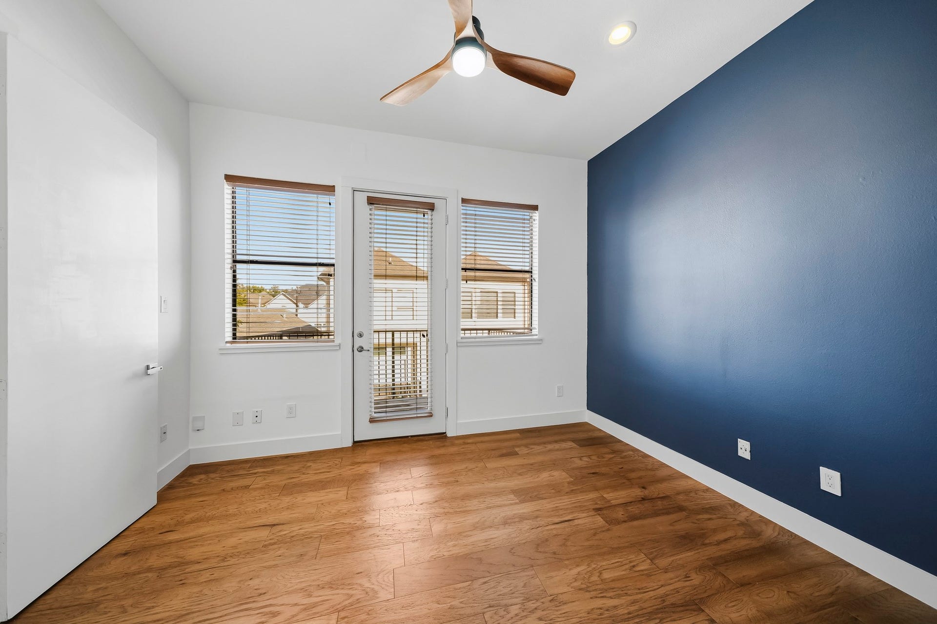 910 Malone Street, #106, Houston, TX 77007 This beautifully appointed secondary bedroom features rich hardwood floors, recessed lighting and a ceiling fan with an integrated light. An impressive 8-foot door opens to a private outdoor patio, bringing in natural light and extending the living space outdoors.