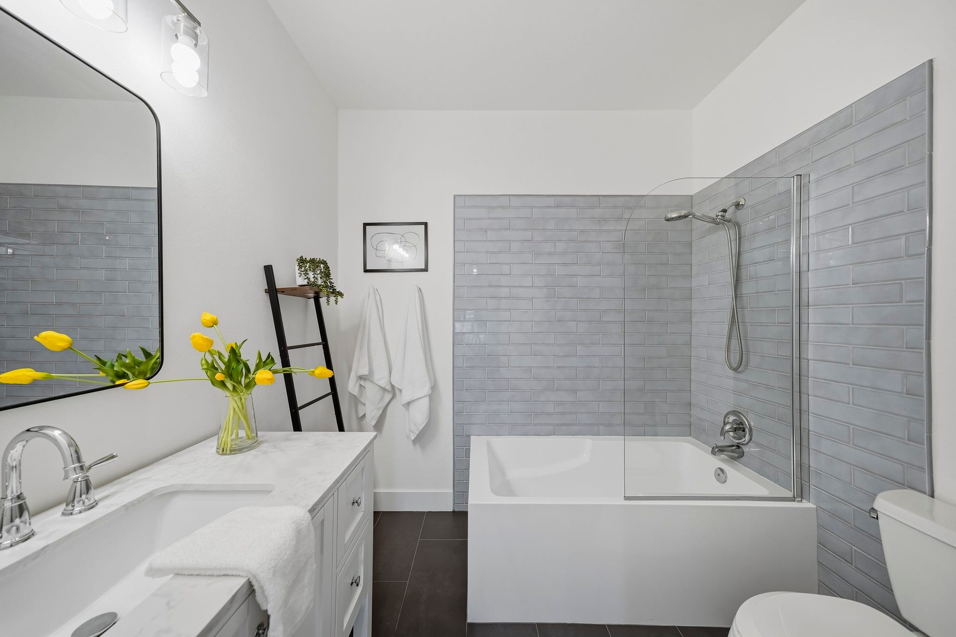910 Malone Street, #106, Houston, TX 77007 The soaking tub and shower combination features a classic subway tile surround, creating a clean, sophisticated look.