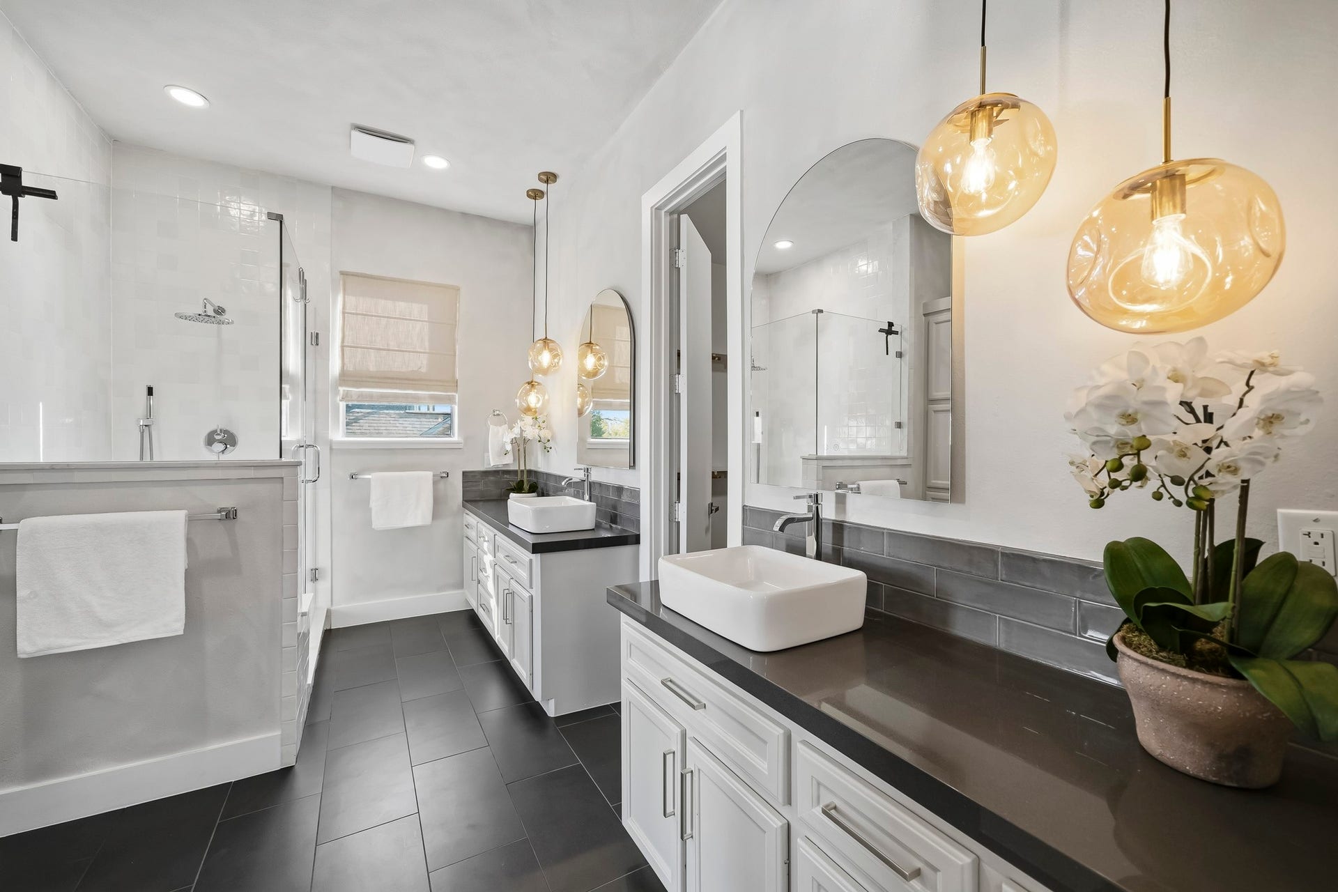 910 Malone Street, #106, Houston, TX 77007 Elegant decorative lighting complements recessed illumination, casting a warm glow across the space, while expansive 12 x 24 tile flooring adds a sophisticated, cohesive finish throughout.