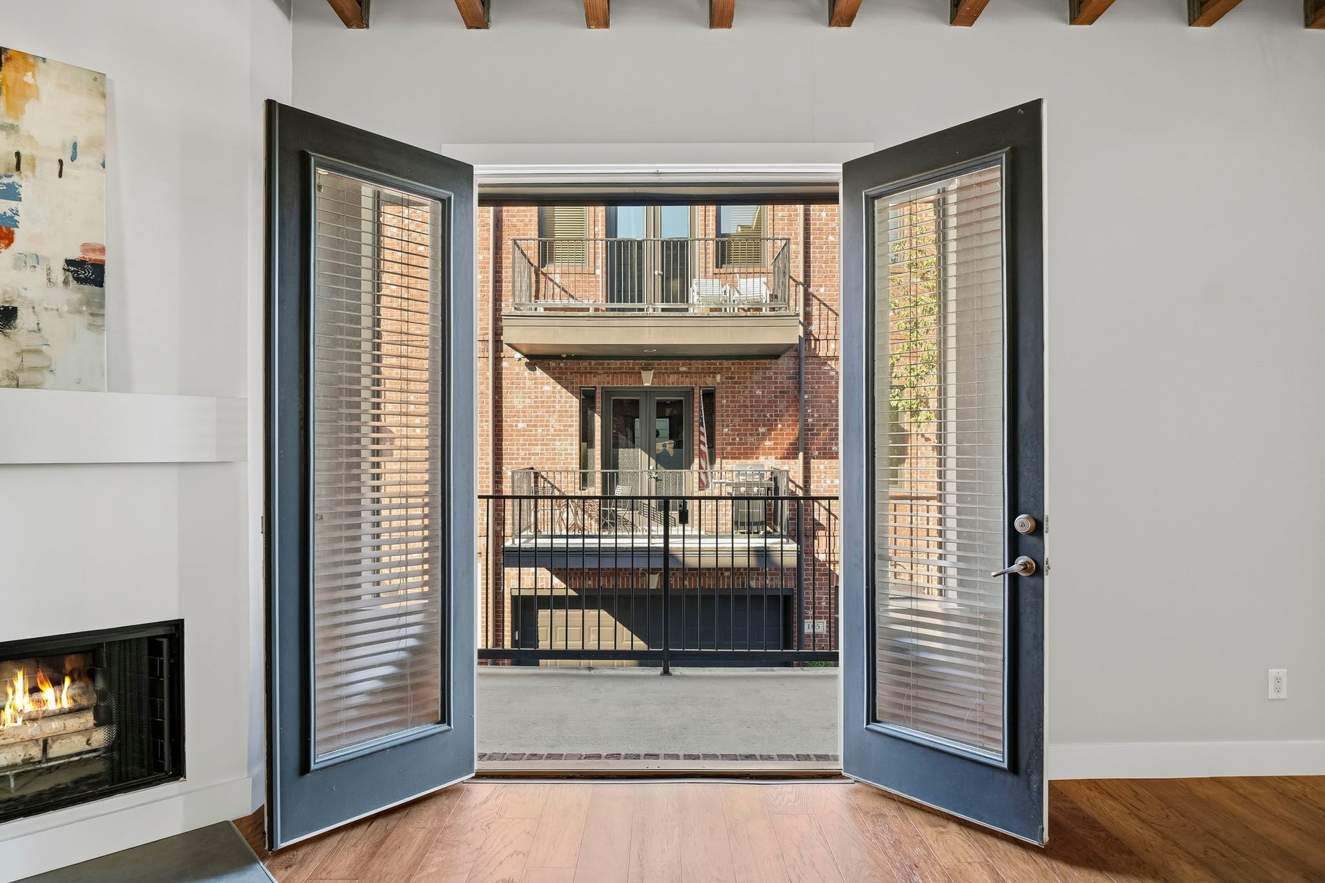910 Malone Street, #106, Houston, TX 77007 Elegant eight-foot French doors open from the family room to a covered balcony, seamlessly extending the living space outdoors. Complete with a gas connection for grilling, this inviting retreat offers the perfect setting for alfresco dining and entertaining.
