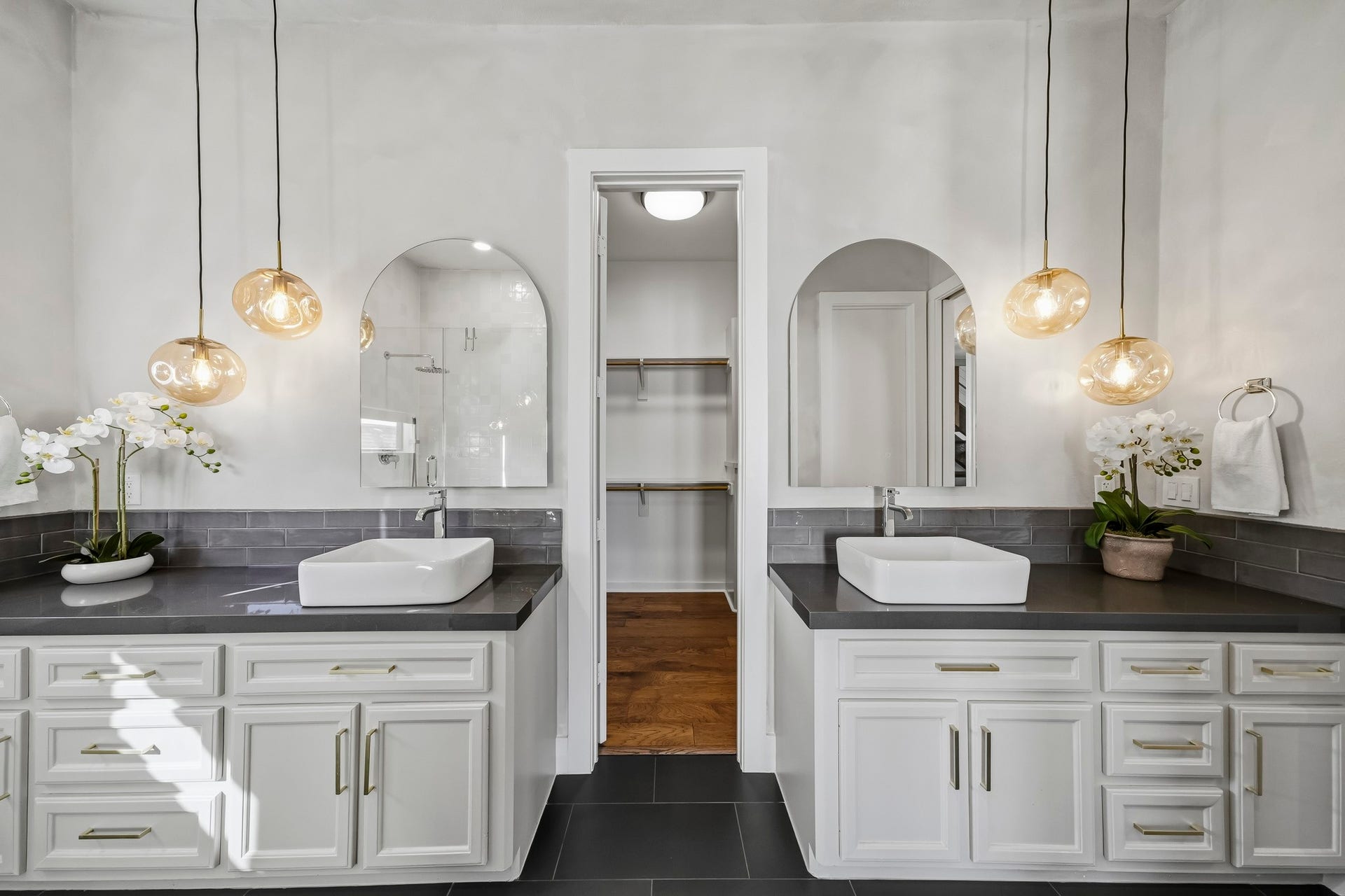 910 Malone Street, #106, Houston, TX 77007 Remodeled in 2025, the beautifully appointed primary bath showcases elegant granite countertops, a classic subway tile back splash and dual vessel sinks, creating a sophisticated space with a touch of modern luxury.