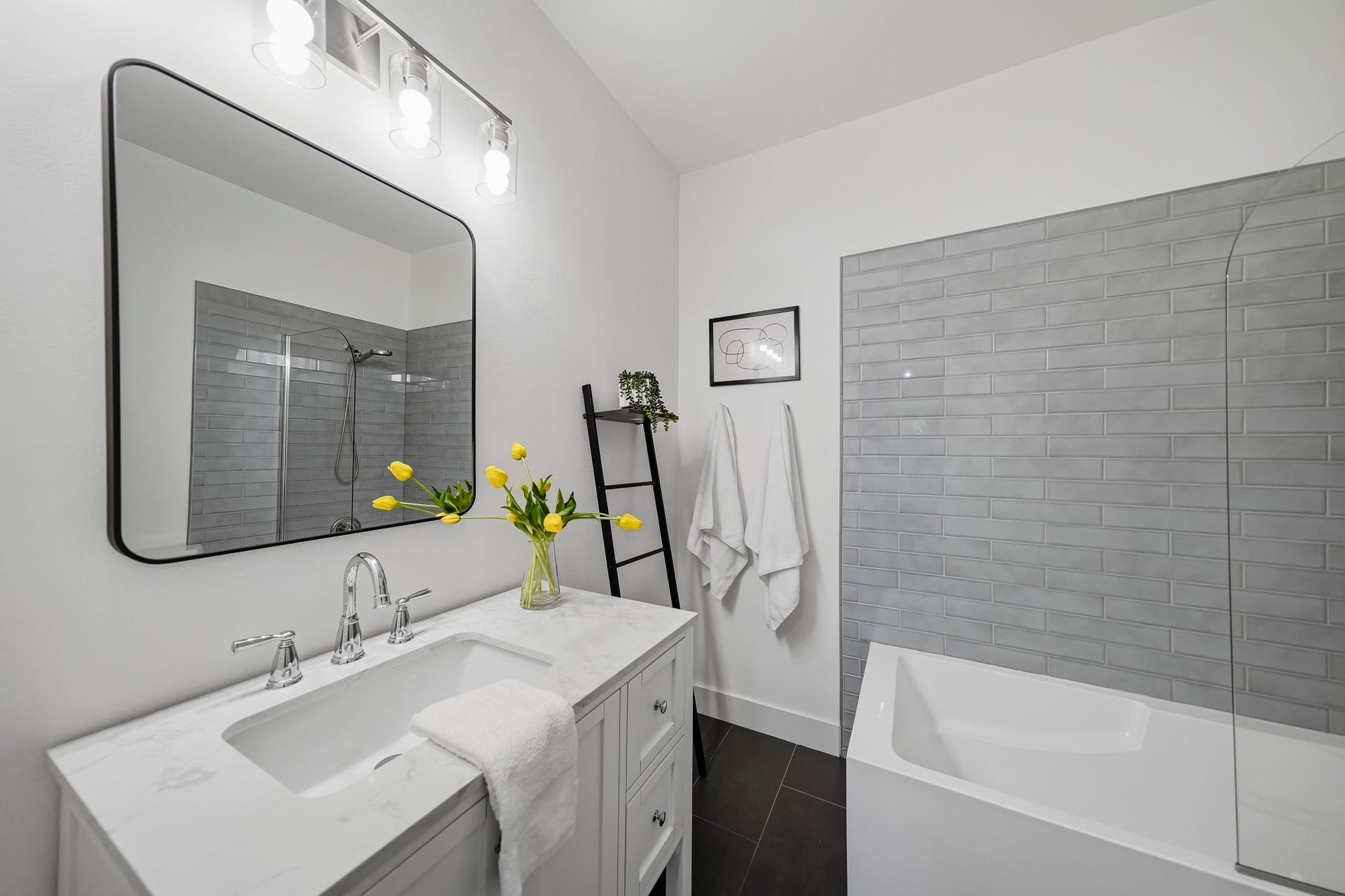 910 Malone Street, #106, Houston, TX 77007 The first-floor ensuite bath was remodeled in 2024 and features elegant tile flooring and a furniture-style vanity topped with a Quartz counter, blending timeless style with modern sophistication.