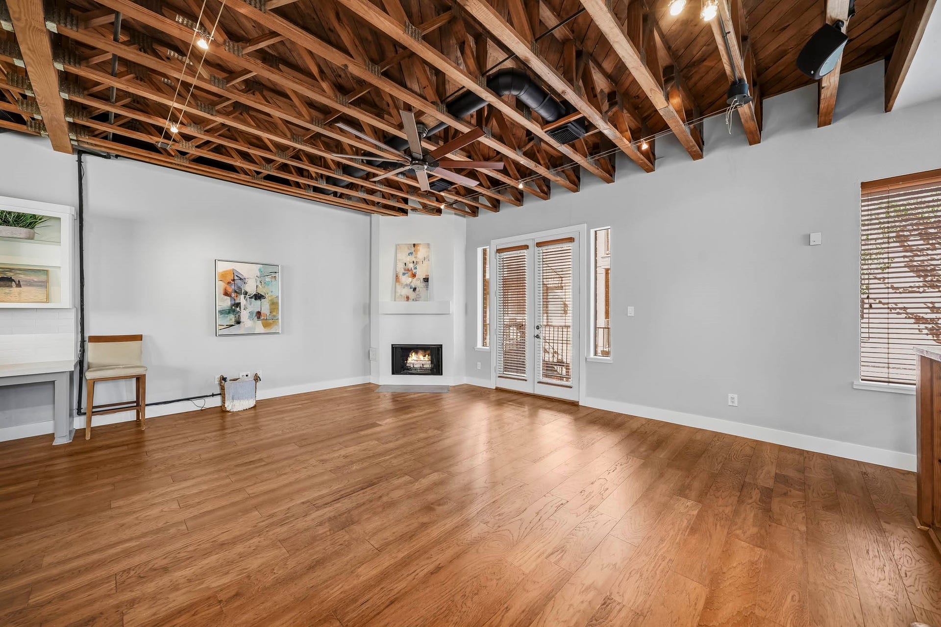 910 Malone Street, #106, Houston, TX 77007 Elegant eight-foot French doors extend the family room onto a covered balcony, creating a seamless connection between indoor and outdoor living.