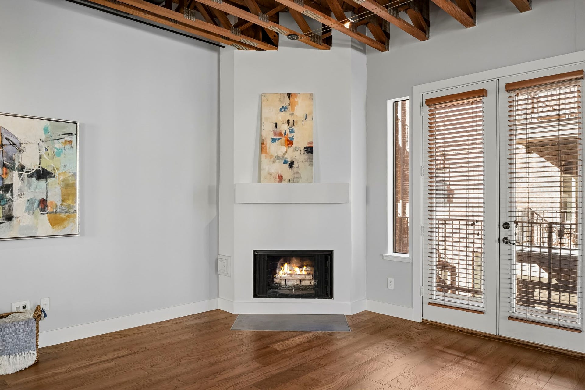 910 Malone Street, #106, Houston, TX 77007 A classic wood-burning fireplace, accented by a wood mantel, creates a striking focal point, while exposed beams and architectural wood trusses lend rich character, timeless charm and an inviting sense of warmth to the space.