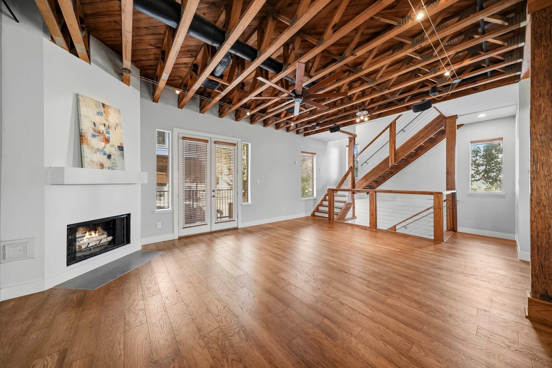 910 Malone Street, #106, Houston, TX 77007 The open staircase ascends gracefully to the third level, creating a sense of spaciousness and architectural continuity throughout the home.