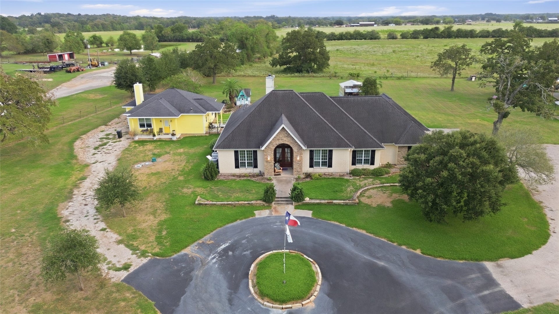 29101 Fm 1736 Road, Hempstead, TX 77445 FRONT ARIAL VIEW OF THE HOMES WITH EXTENDED DRIVEWAY TO THE 3-CAR GARGE CAN BE SEEN