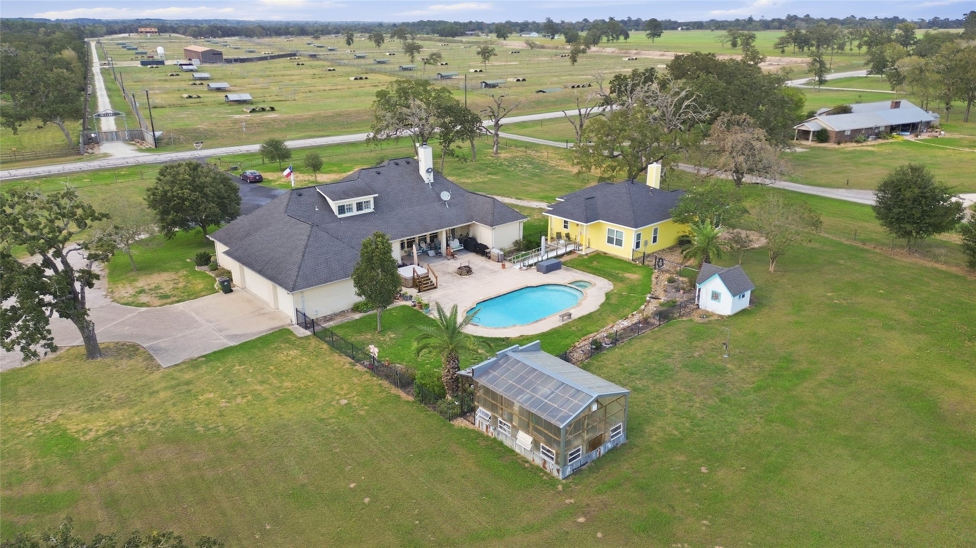 29101 Fm 1736 Road, Hempstead, TX 77445 BACK VIEW OF THE HOMES WITH THE GREENHOUSE AND THE CIGAR MINI HOME CAN BE SEEN
