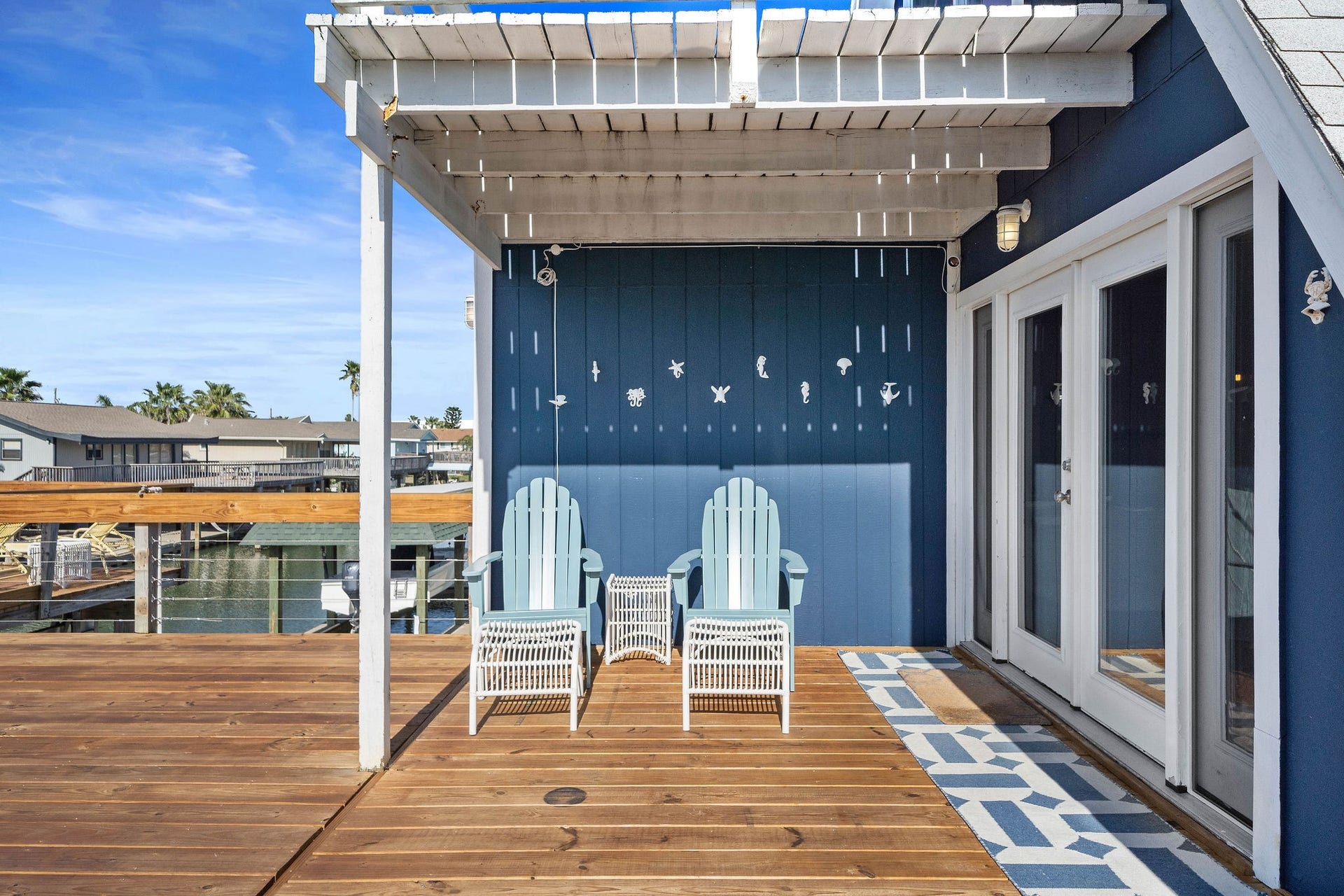 16610 Nassau Way, Galveston, TX 77554 Charming waterfront deck with a pergola, offering a perfect spot to relax and enjoy the view.