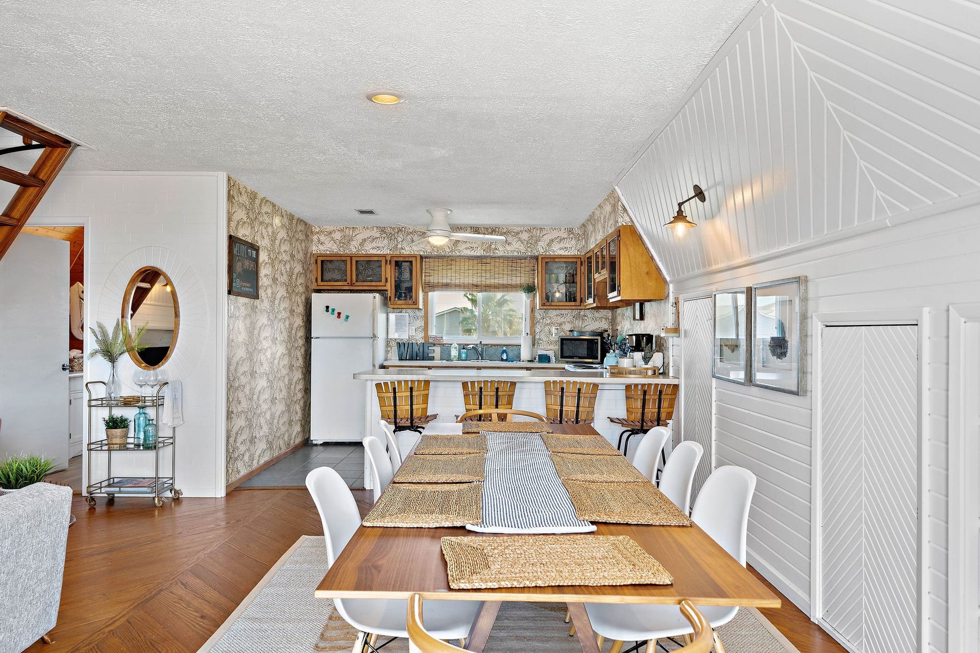 16610 Nassau Way, Galveston, TX 77554 Open-concept dining area with a rustic kitchen featuring wood cabinetry and vintage charm, perfect for entertaining.