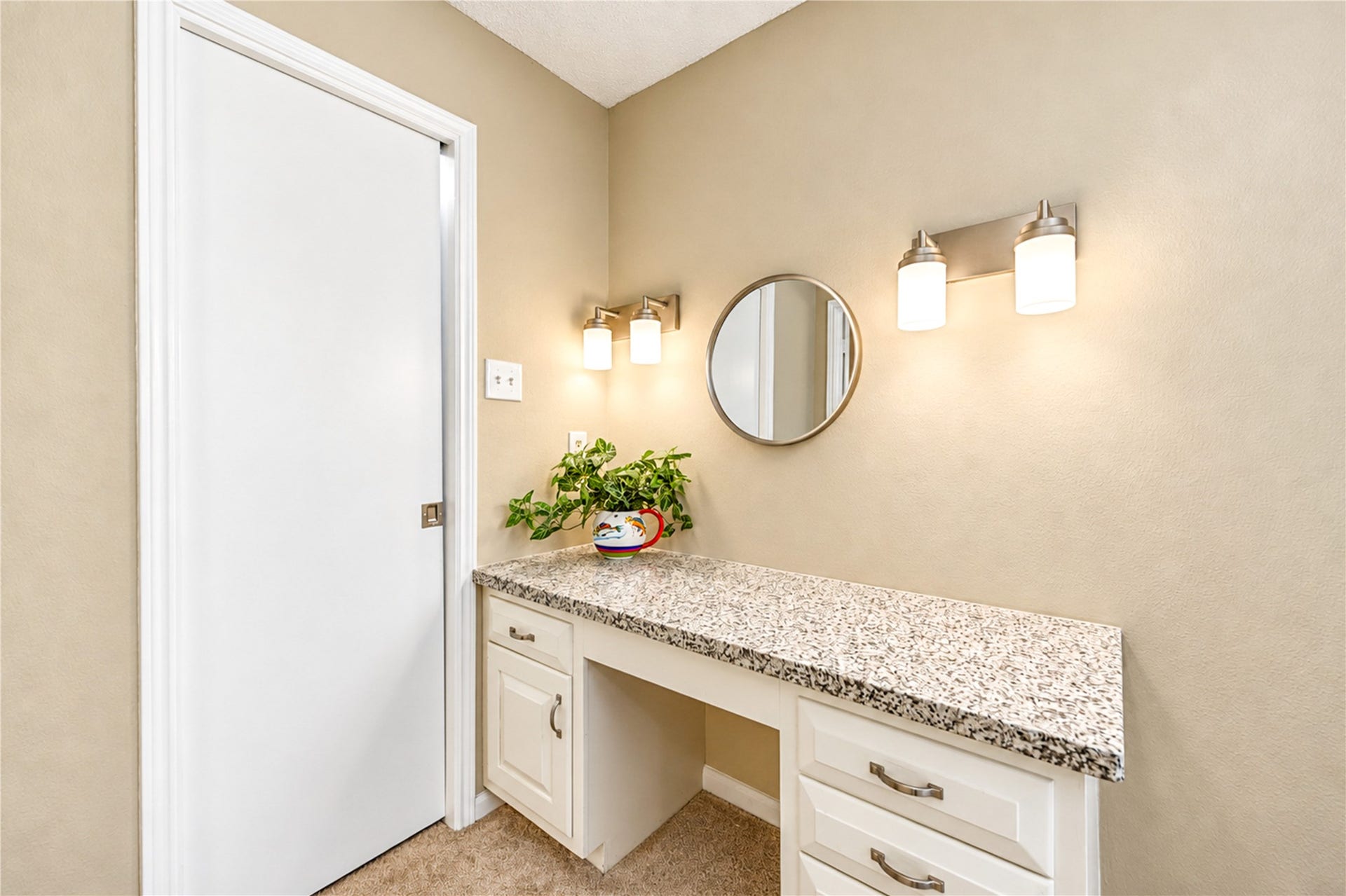 361 Champions Colony III, Houston, TX 77069 Charming vanity area with a sleek granite countertop, ample drawer storage, and elegant lighting, perfect for a personal retreat.