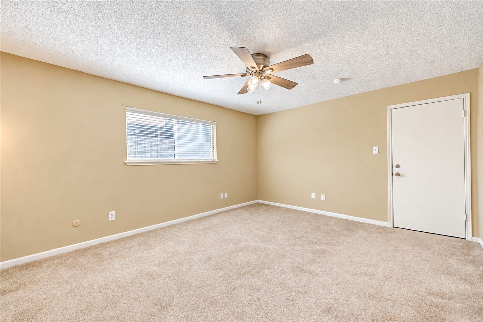 361 Champions Colony III, Houston, TX 77069 Spacious secondary bed room with soft carpet flooring, a brand new ceiling fan for comfort, and ample natural light through a large window.