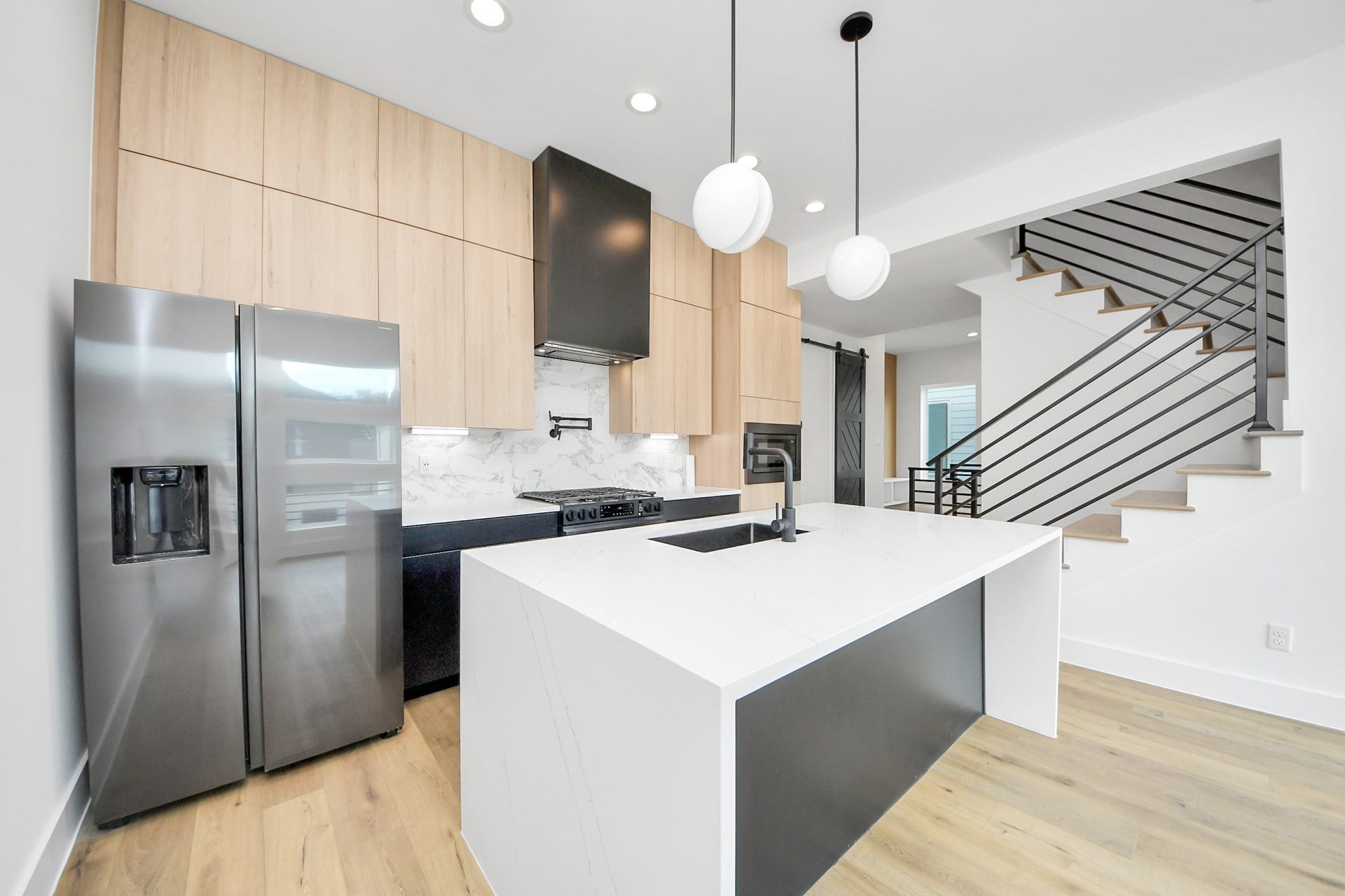 5030 Mallow Street, #A/B, Houston, TX 77033 Unit B - Kitchen boasts waterfall countertops, potfiller, and stainless steel appliances