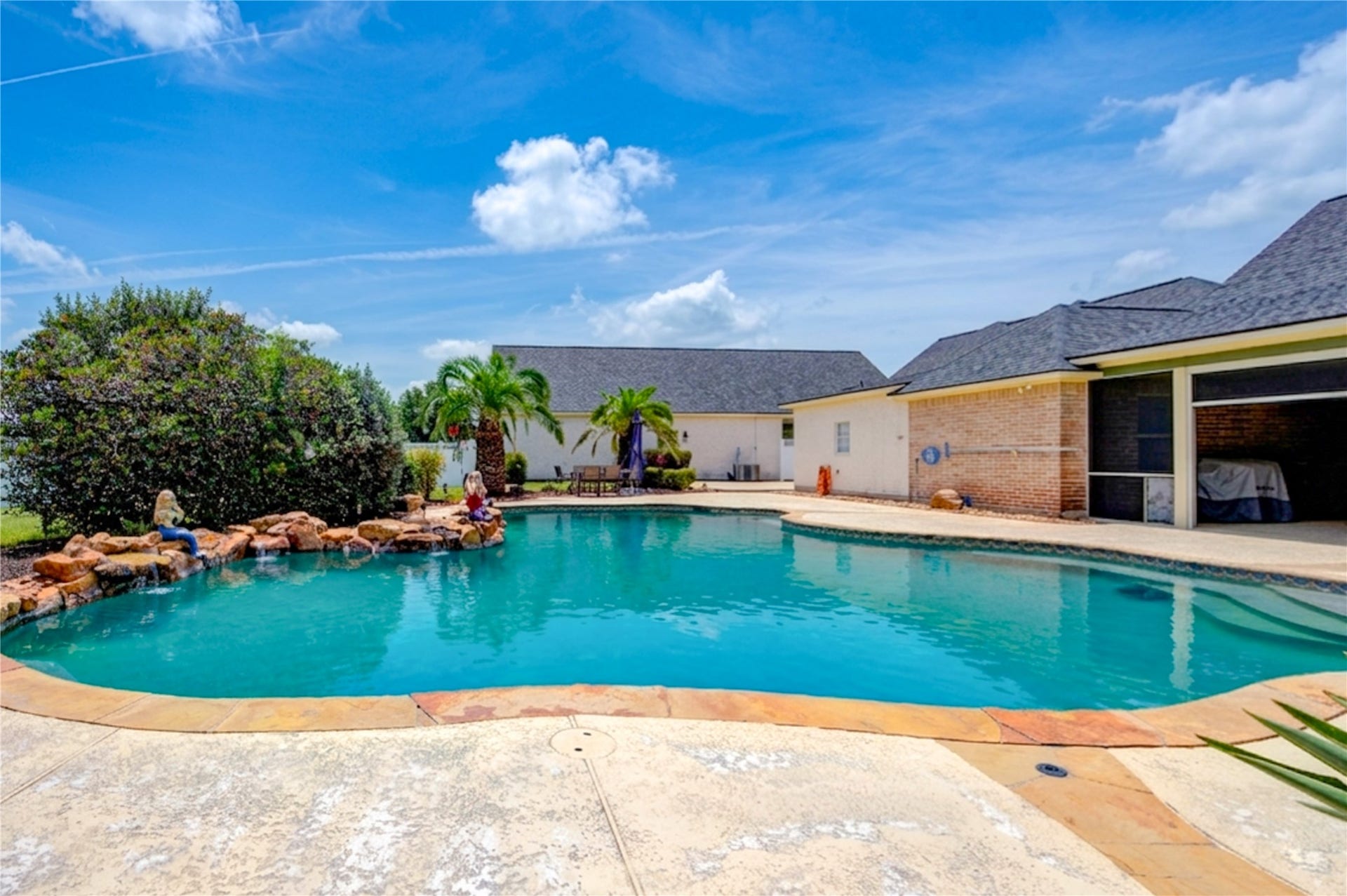 15302 Devin Lane, Crosby, TX 77532 Stunning pool wit hot tub, covered patio and outdoor kitchen. Remote controlled screens for patio too!