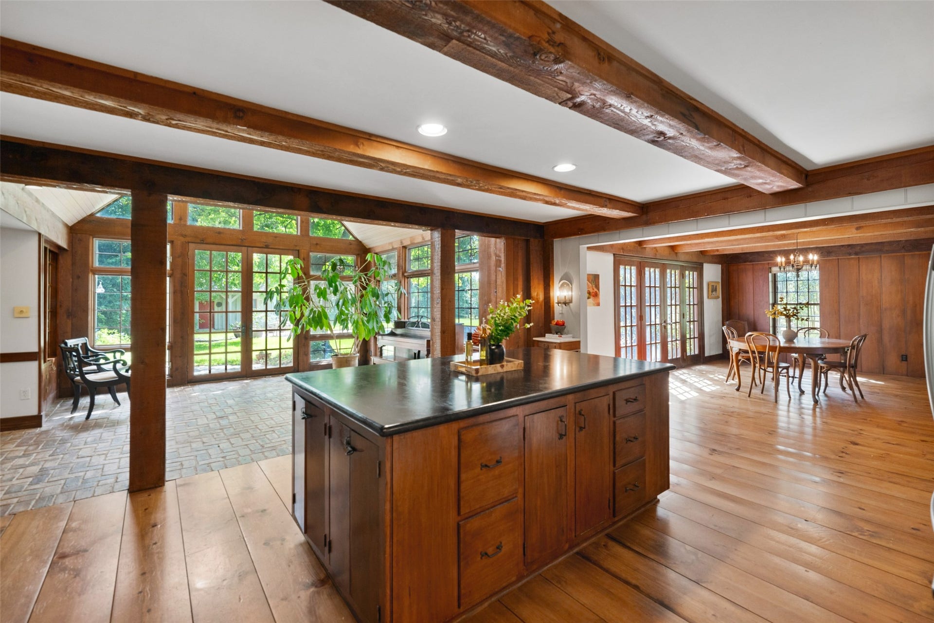 38914 Sampson Road, Brookshire, TX 77423 At the heart of the home, the kitchen brings together exposed beams, wide-plank floors and warm wood details, with beautiful sightlines into the sunroom and dining space.