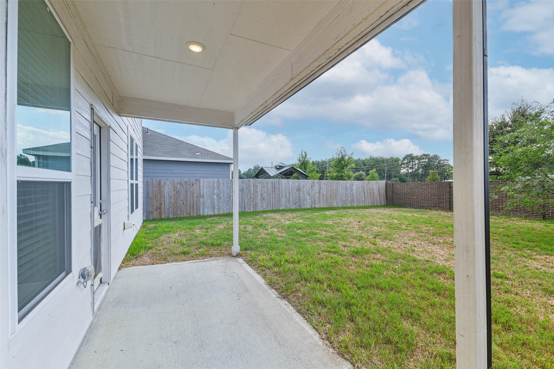 25631 Balsamroot Drive, Magnolia, TX 77355 Enjoy the backyard from the covered patio.