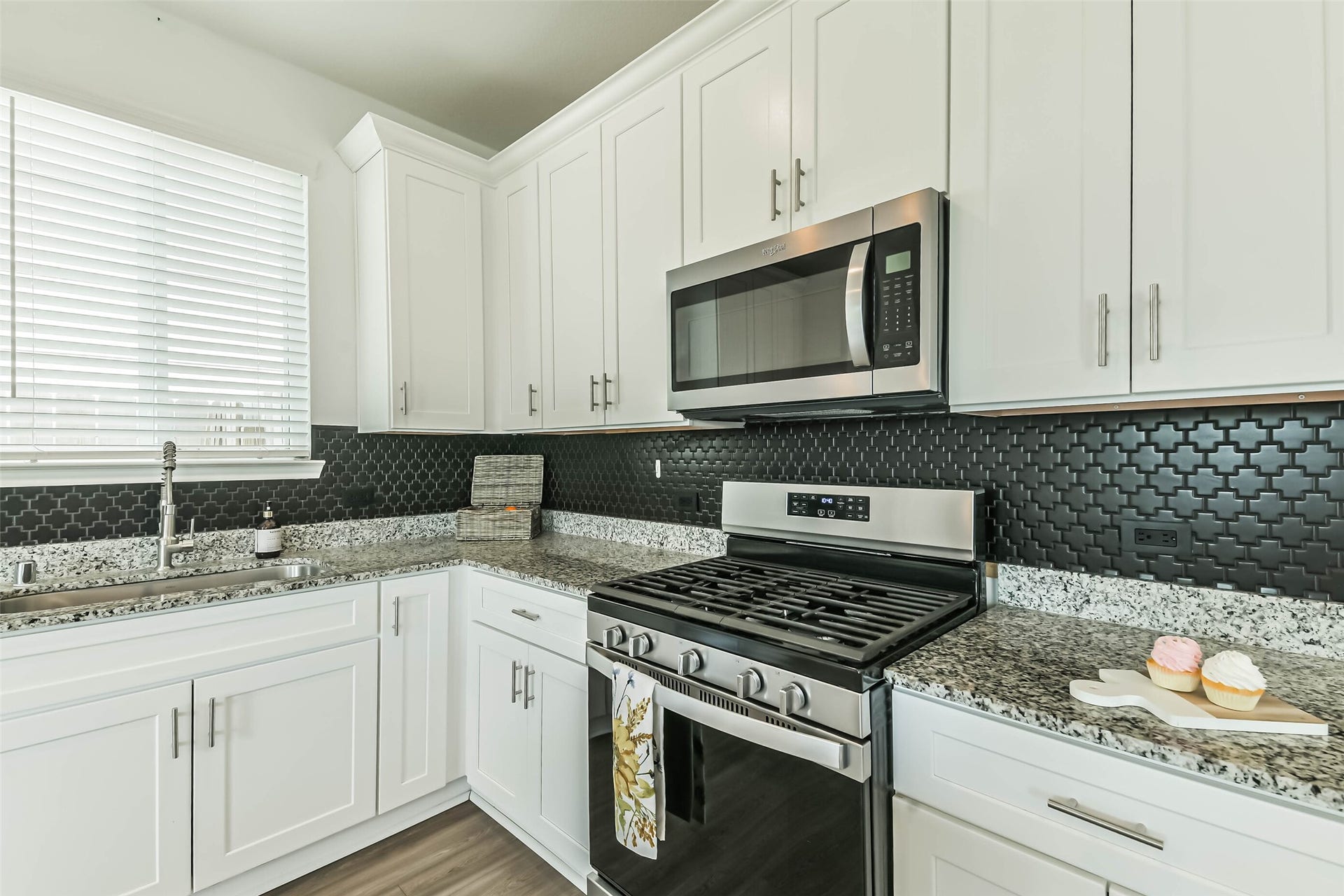 25631 Balsamroot Drive, Magnolia, TX 77355 Note the stainless steel appliances, window overlooking the sink, and modern drawer and cabinet pulls.
