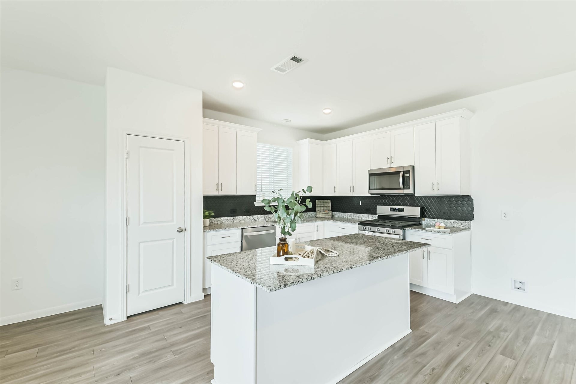 25631 Balsamroot Drive, Magnolia, TX 77355 The large island in the kitchen with a counter height bar.