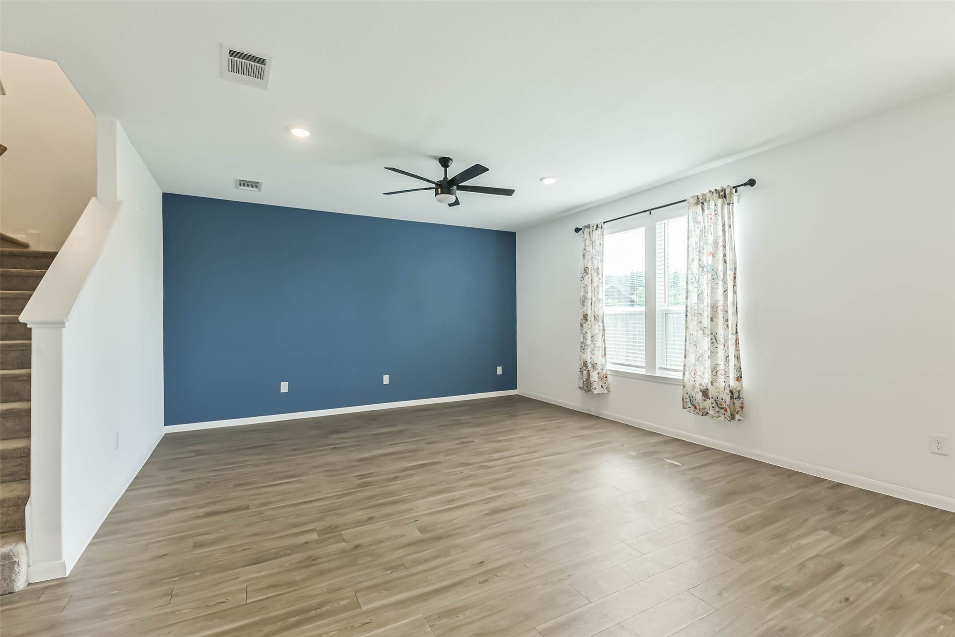 25631 Balsamroot Drive, Magnolia, TX 77355 The living room is open and has windows overlooking the backyard.