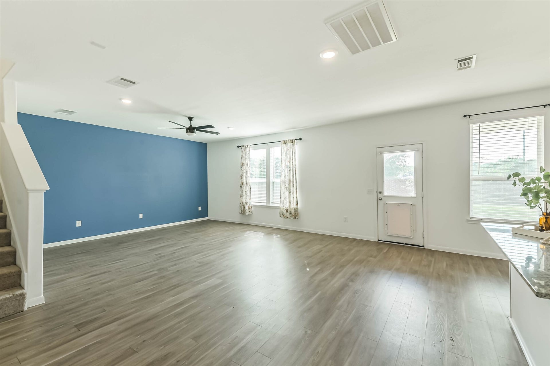 25631 Balsamroot Drive, Magnolia, TX 77355 The living room features a designer-inspired accent wall.