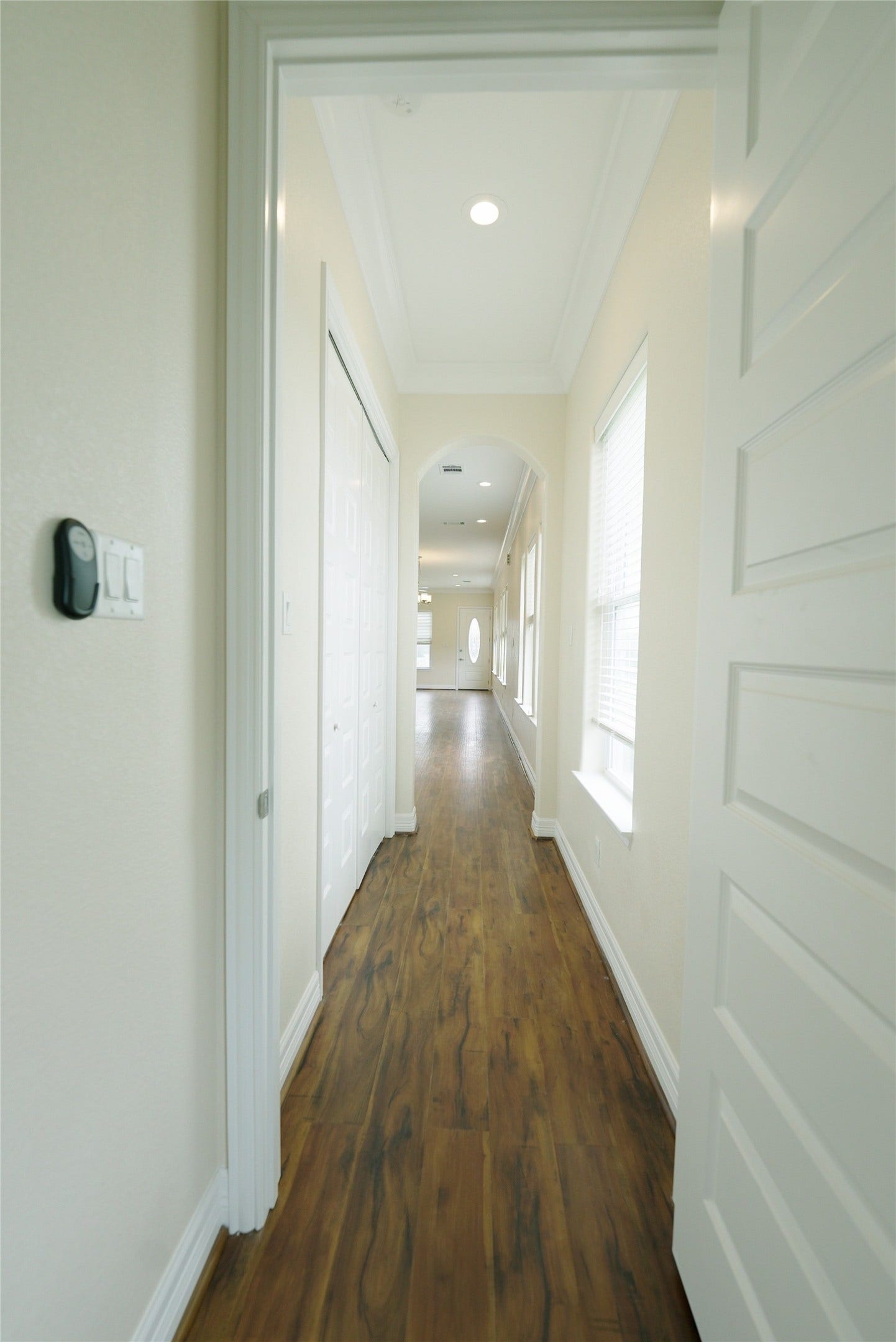 1013 10th Street, Galveston, TX 77550 Guest bedroom features elegant hardwood floors leading to an inviting kitchen and living area. Currently tenant occupied.