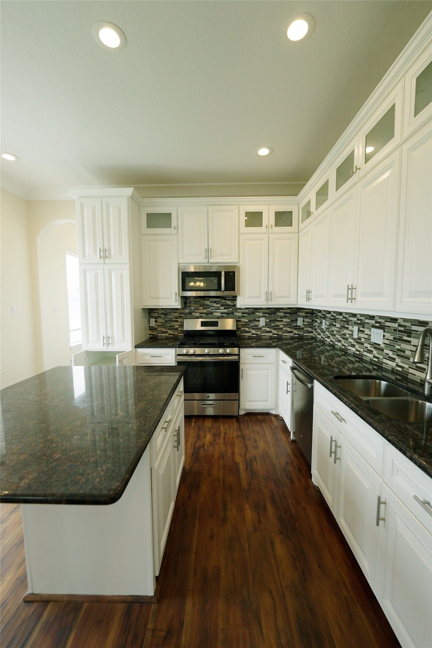 1013 10th Street, Galveston, TX 77550 Elegant kitchen with a spacious island and ample storage, perfect for culinary enthusiasts. Currently tenant occupied.
