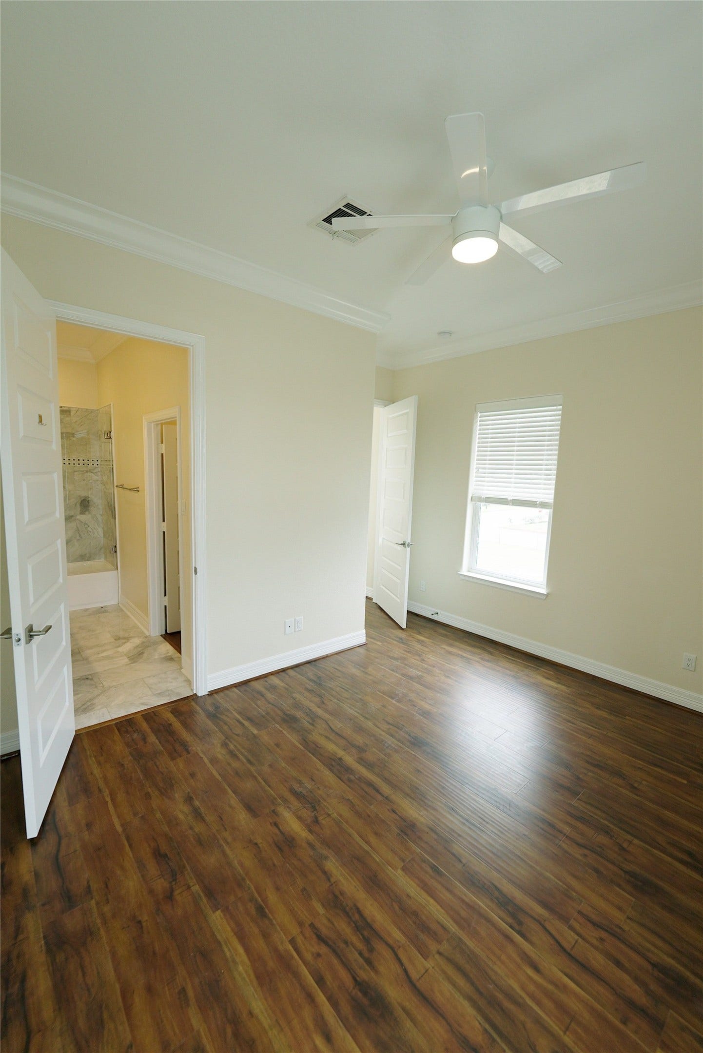1013 10th Street, Galveston, TX 77550 Elegant guest bedroom featuring stunning hardwood floors. Currently tenant-occupied.