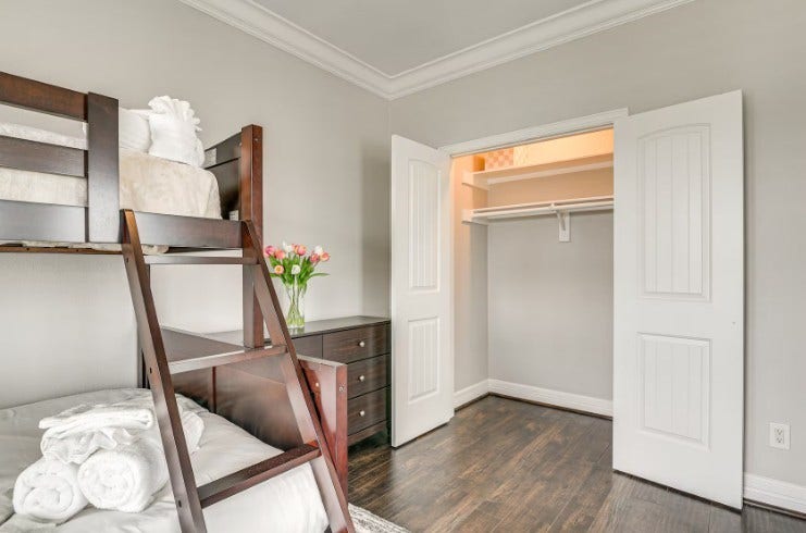 1013 10th Street, Galveston, TX 77550 Elegant top-level guest bedroom, fully furnished for comfort and style.