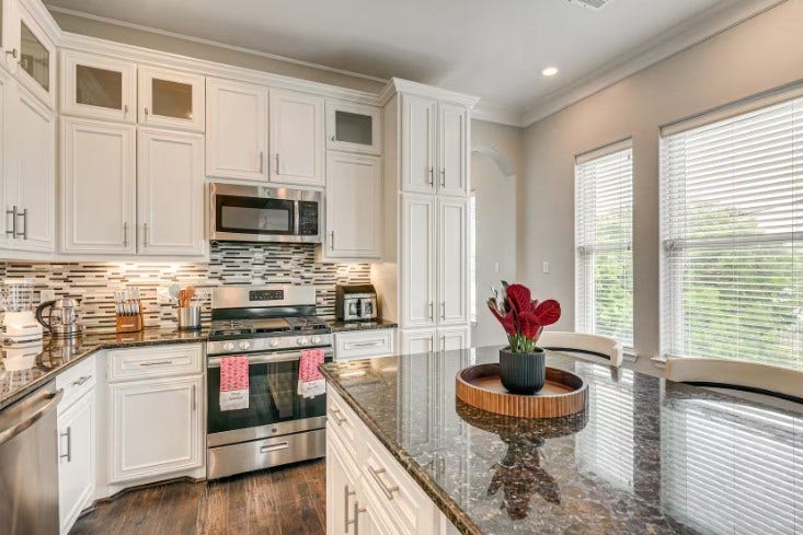 1013 10th Street, Galveston, TX 77550 Elegant and fully furnished kitchen at 1013 10th A, featuring modern appliances, chic cabinetry, and ample natural light.