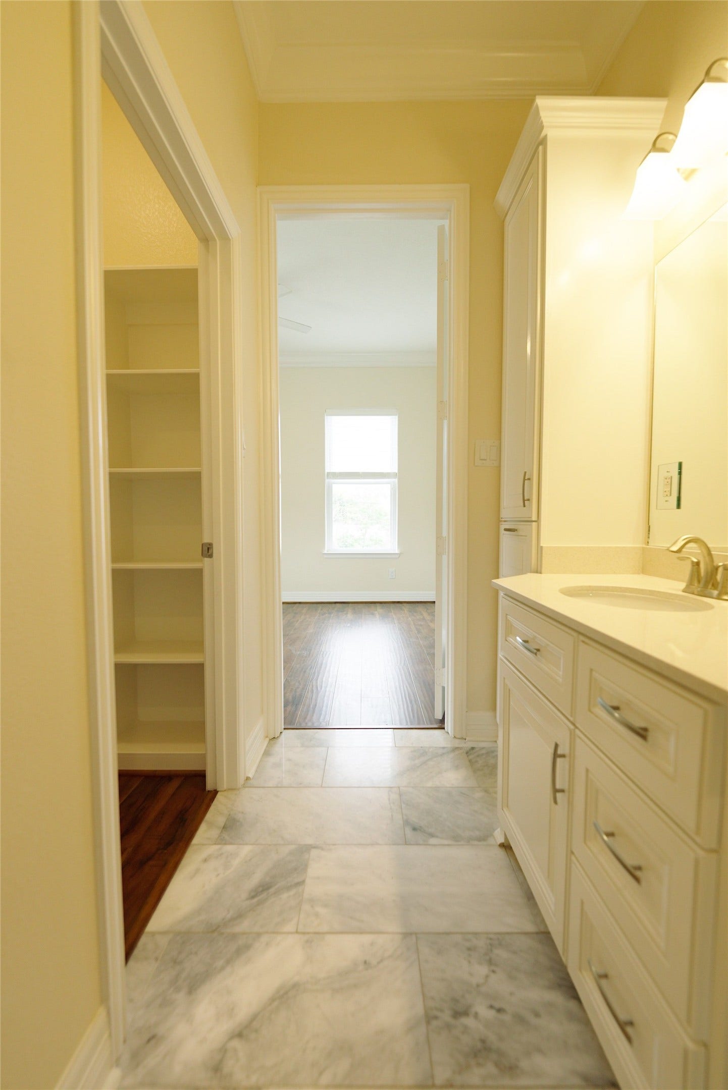 1013 10th Street, Galveston, TX 77550 Elegant guest bathroom featuring luxurious marble floors and a spacious walk-in closet.