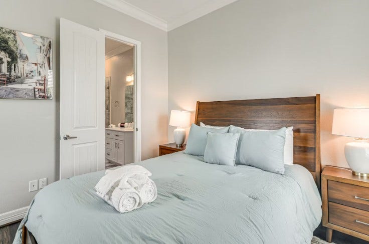 1013 10th Street, Galveston, TX 77550 Charming guest bedroom, fully furnished for comfort and style, offering a serene retreat for visitors.