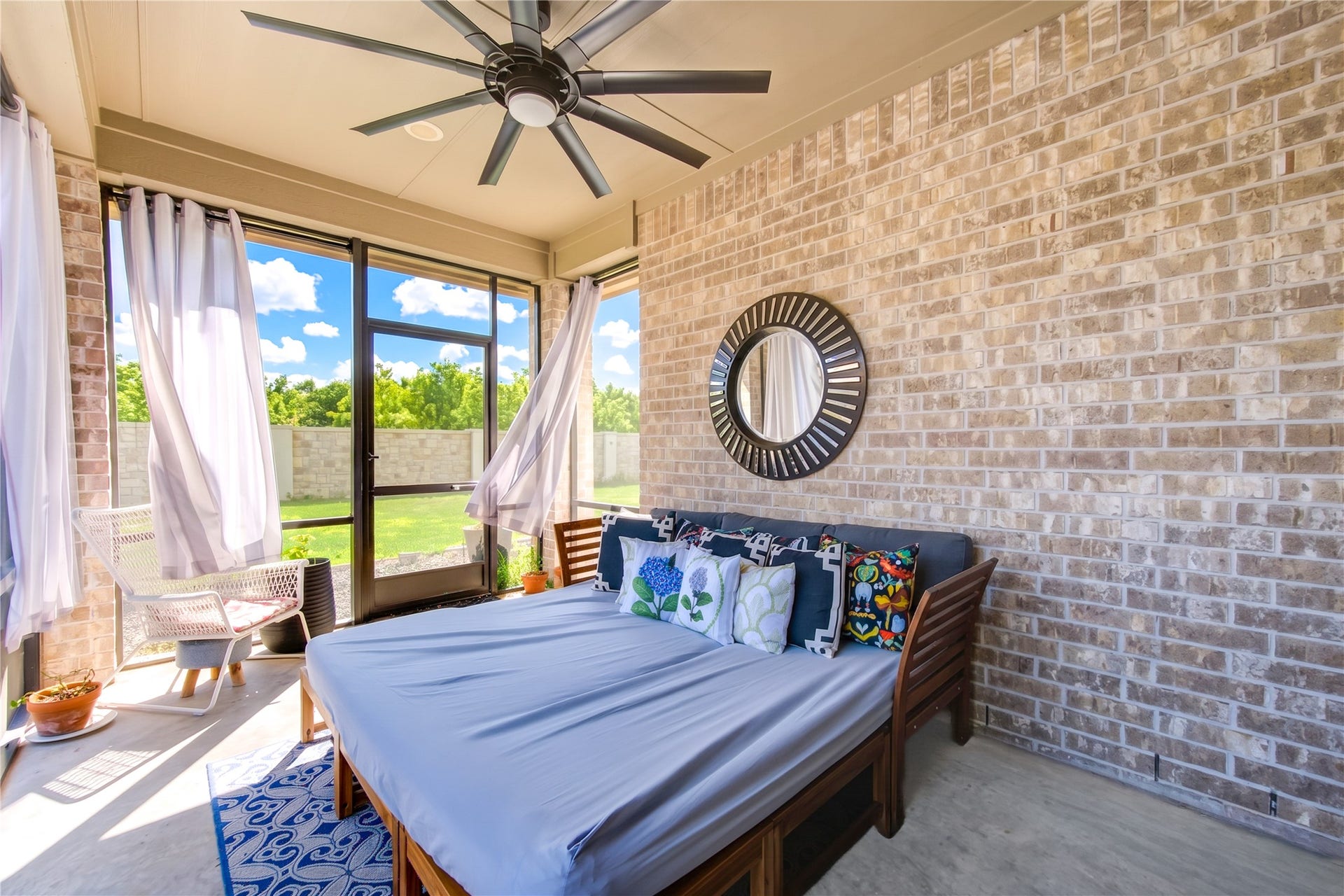 A screened-in, covered back patio offers the perfect place to enjoy your backyard day or night, rain or shine.