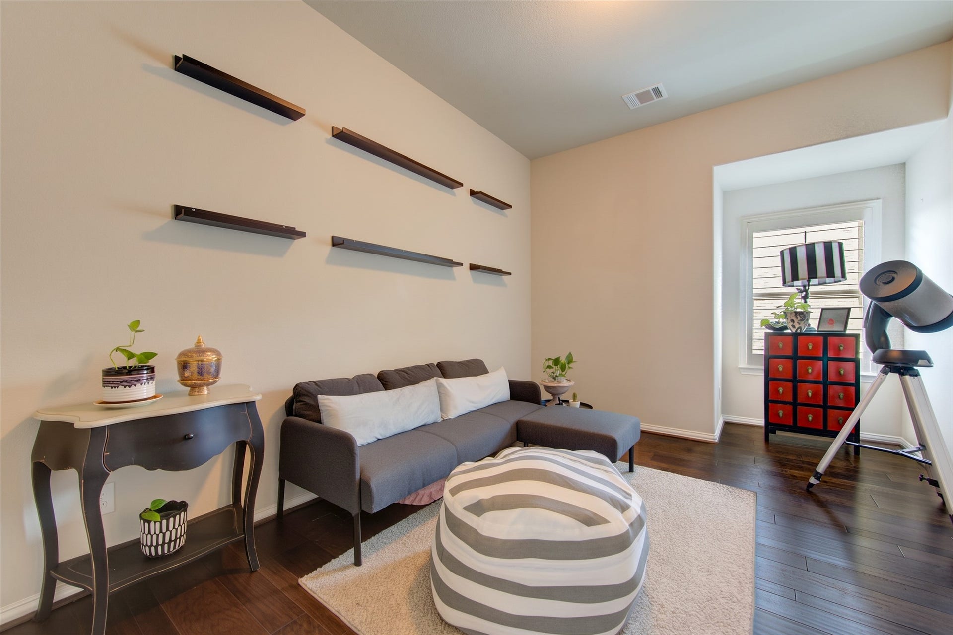 An additional office or sitting area is conveniently located just off the open game room, offering a versatile space for working from home, studying, or creating a cozy retreat.