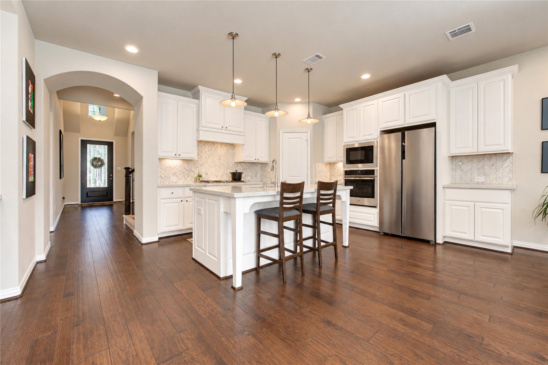 The open-concept floor plan is ideal for entertaining, with the kitchen flowing seamlessly into the family room and breakfast area to create a welcoming space for gathering with family and friends.