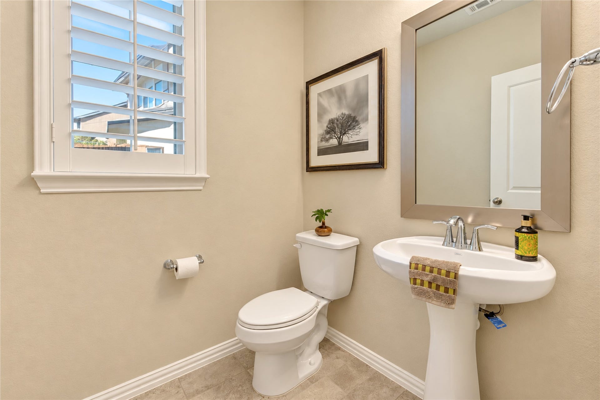 The conveniently located half bath offers easy access for guests, adding comfort and convenience when entertaining.