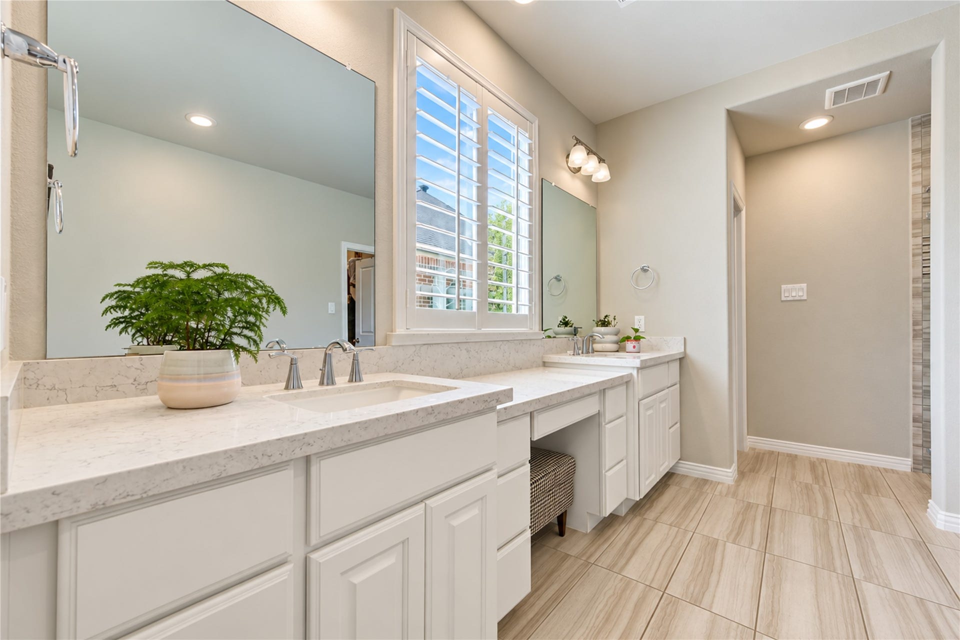 The spacious primary bath features a relaxing soaking tub, a walk-in tile shower, generous vanity space, and dual sinks, creating a comfortable retreat for everyday living.