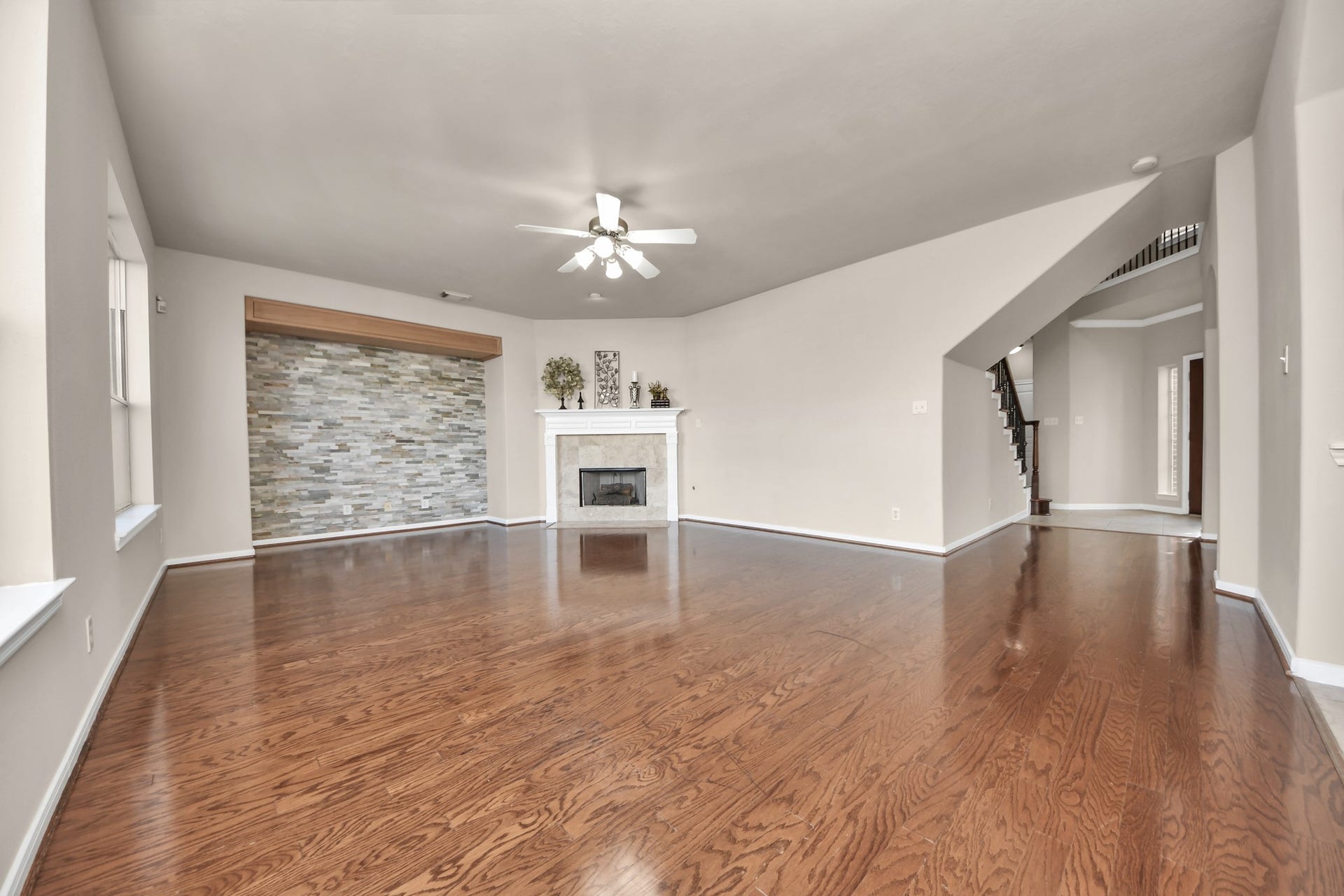 17418 Memorial Mills Drive, Spring, TX 77379 A bold accent wall and a gas-log fireplace create an inviting atmosphere in this cozy family room.