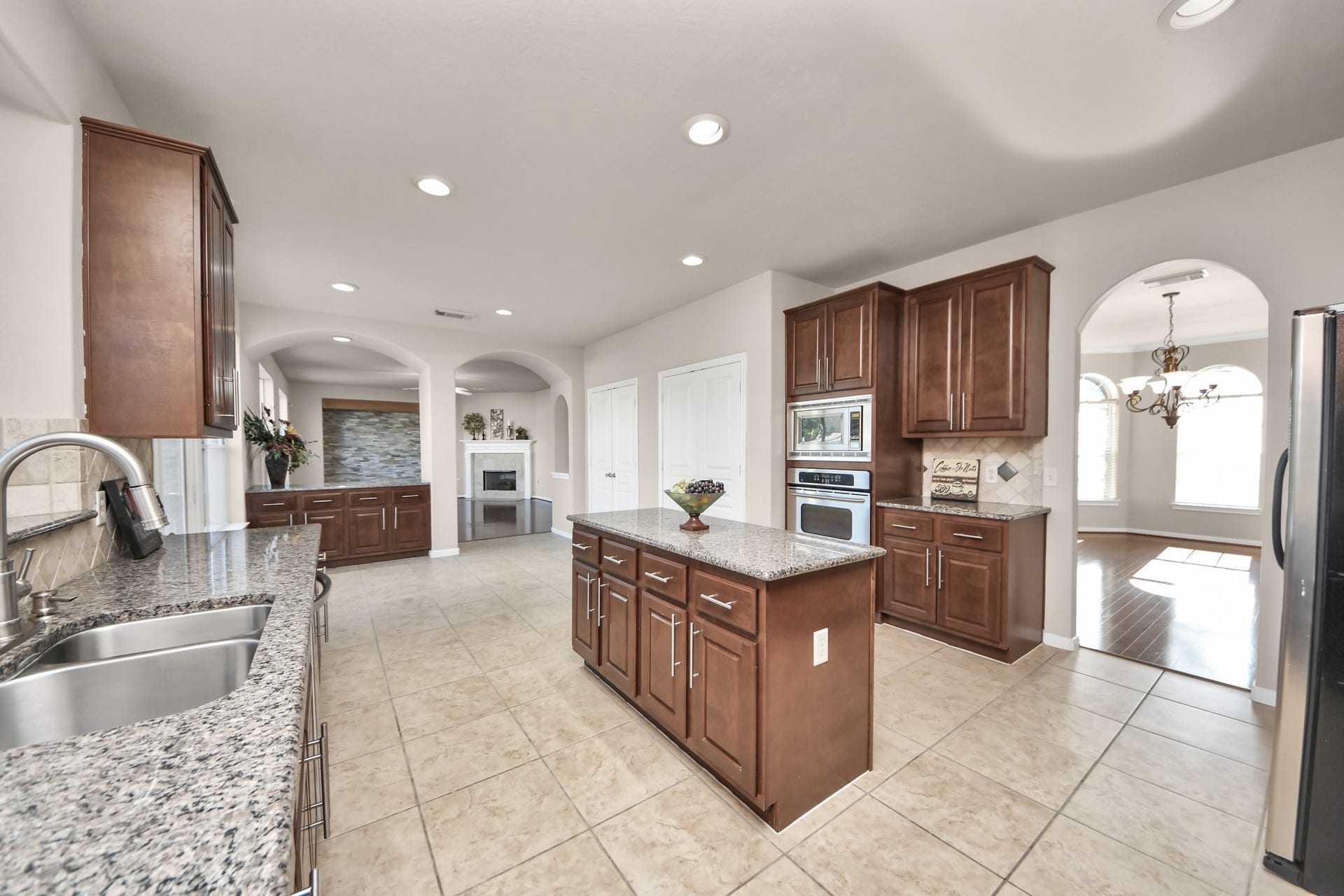 17418 Memorial Mills Drive, Spring, TX 77379 The spacious island kitchen flows seamlessly into the formal dining room, breakfast area, and living space, creating an ideal layout for both everyday living and entertaining.
