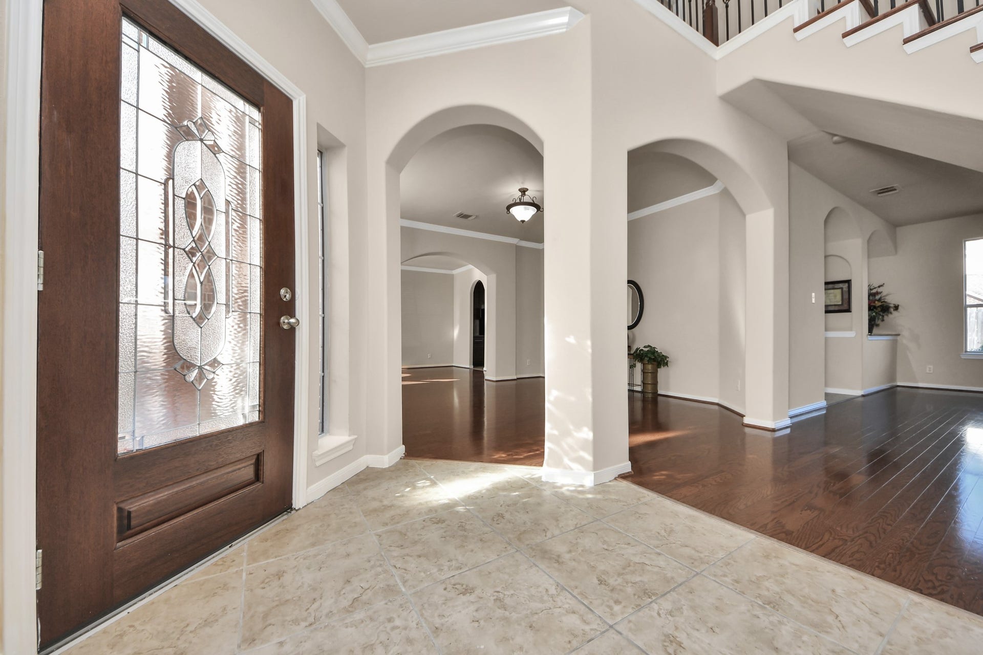 17418 Memorial Mills Drive, Spring, TX 77379 The beautiful front entry showcases Village Builders timeless architectural design, featuring elegant crown molding, rich wood flooring, graceful arches, decorative insets, and an abundance of natural light that welcomes you at every turn!