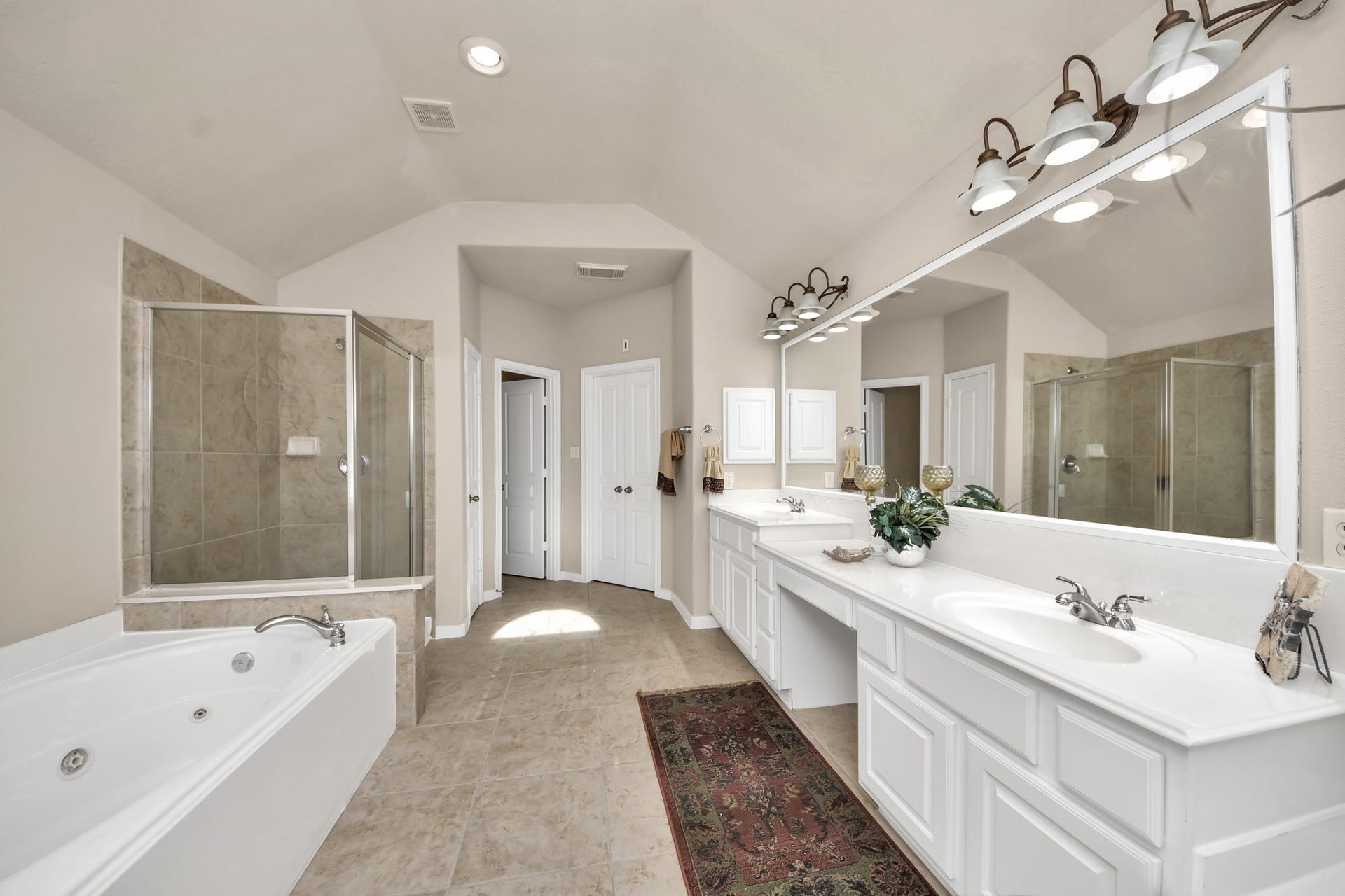 17418 Memorial Mills Drive, Spring, TX 77379 This bathroom features high ceilings, double sinks, and a vanity, providing a complete and functional space.