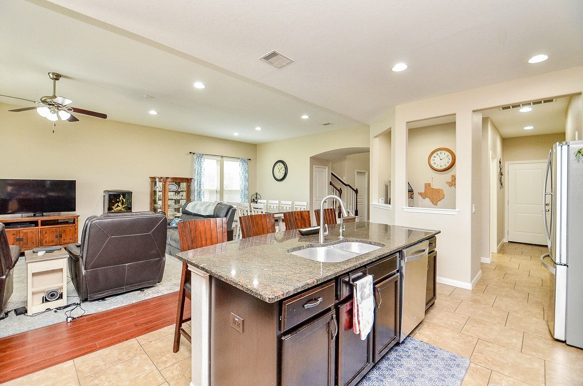19802 Mulberry Pine Lane, Cypress, TX 77429 The large kitchen island with granite countertops opens up to the great room living room and dining room combination. There is an additional space next to the kitchen that could be used as a bar or smart home station.