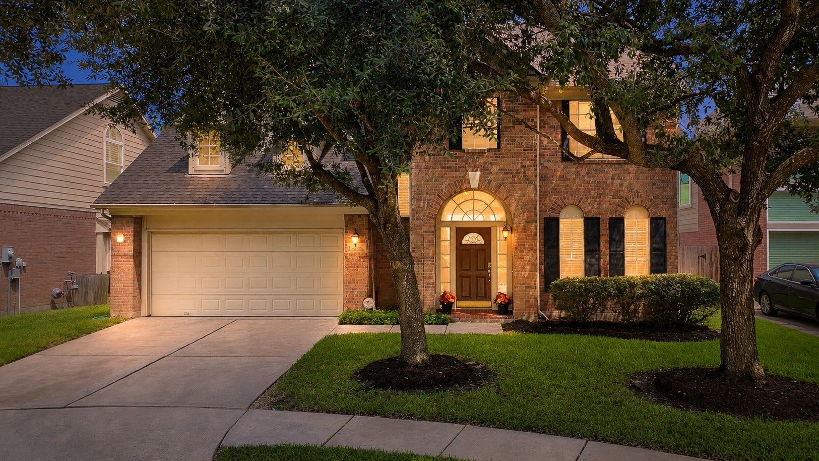 22418 Rue Canyon Court, Katy, TX 77450 Beautiful two-story exterior framed by mature trees with a welcoming front entrance.