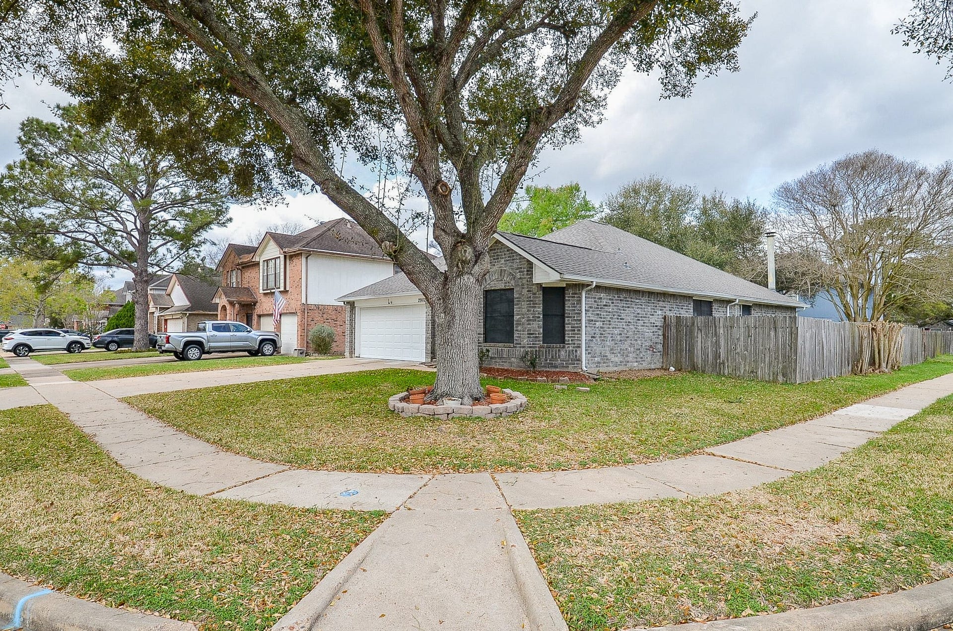 Located on a corner lot with a mature tree provides a bit more space.